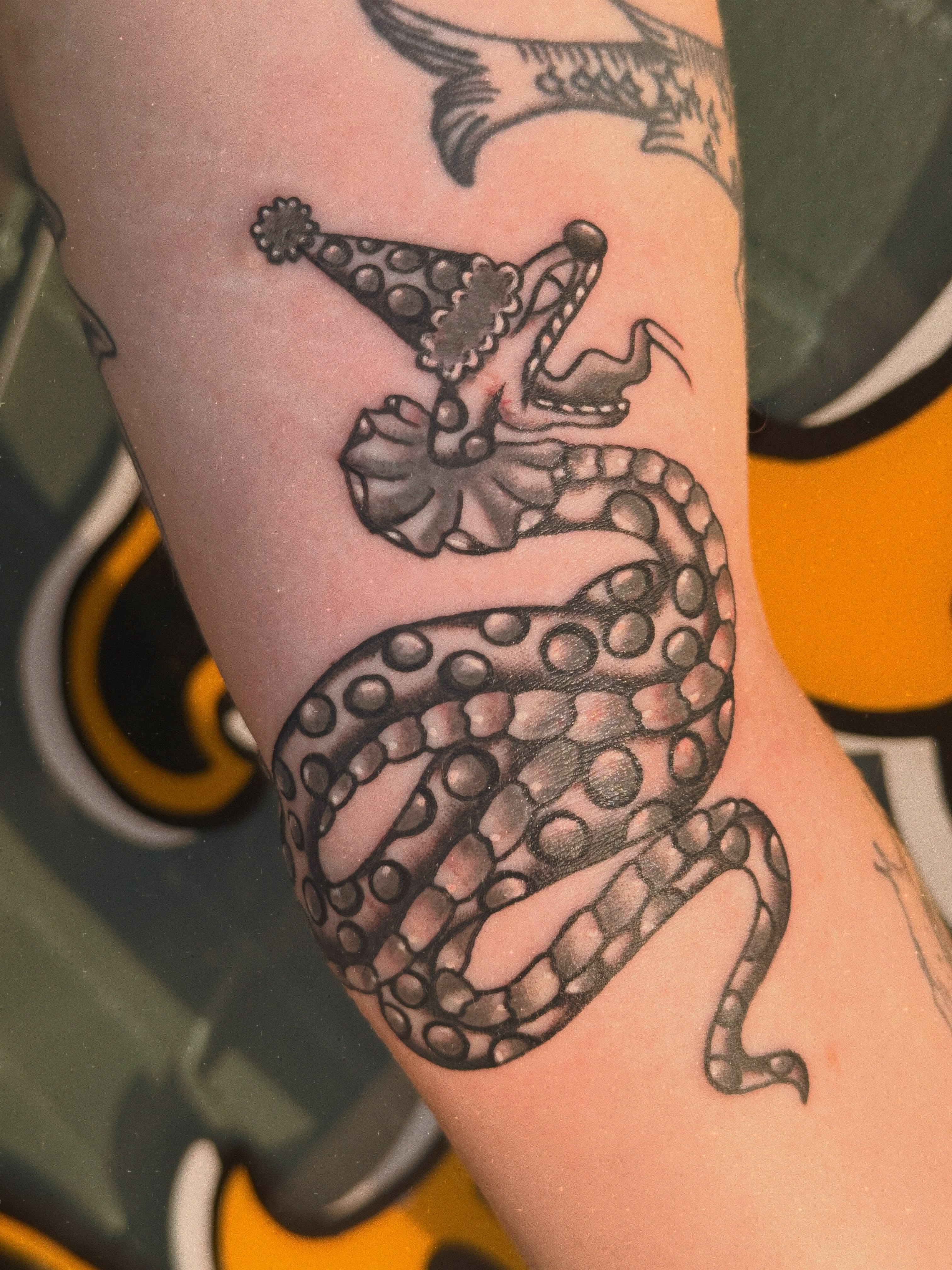Snake with crown dotwork tattoo on the forearm by Megan Sue Causemaker