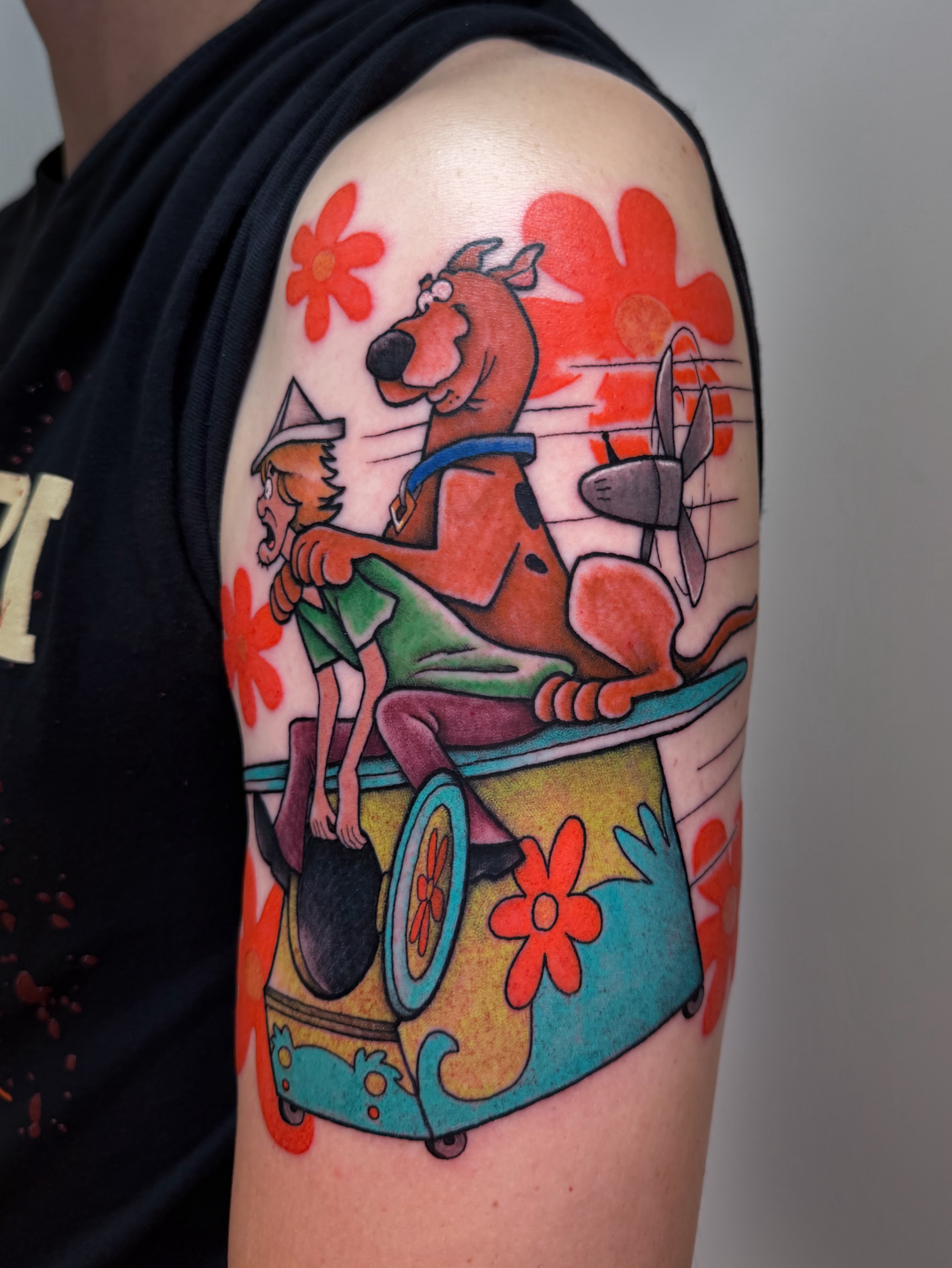 Scooby-Doo and Shaggy illustrative tattoo on the upper arm by rocky love