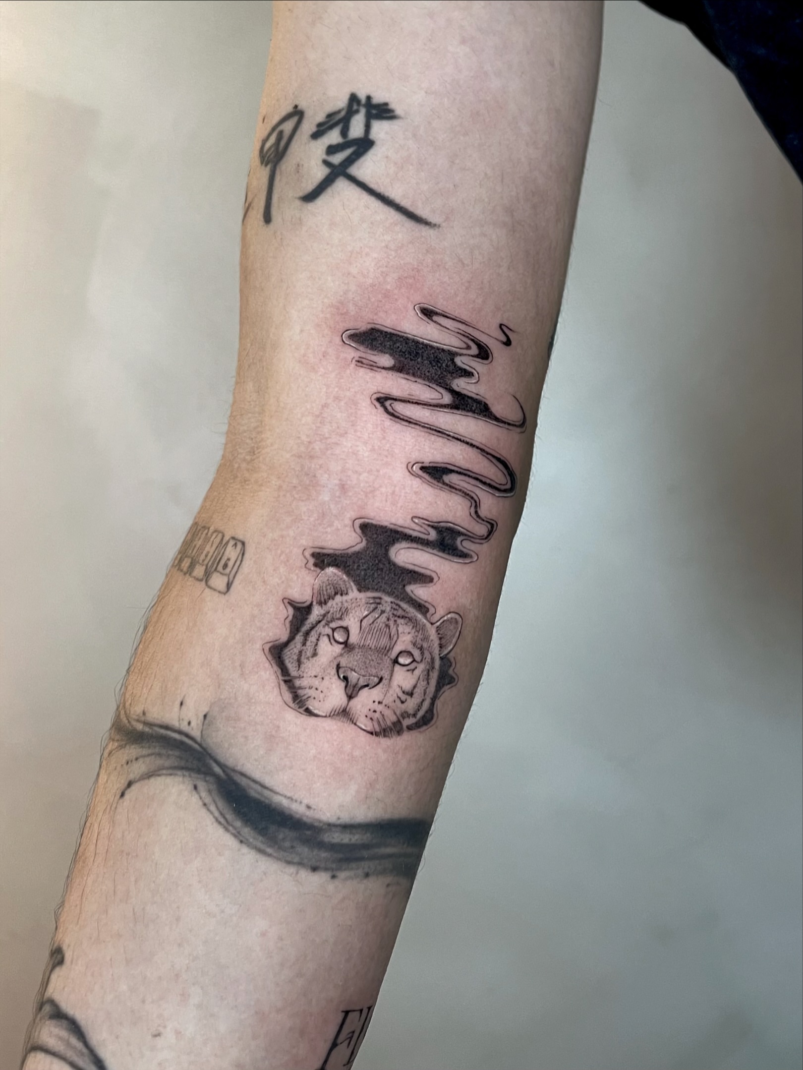 Tiger black and grey tattoo on the forearm by Arhem Quiambao