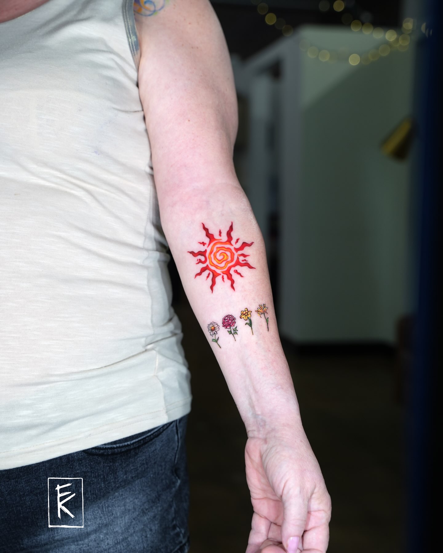 Sun and flowers new school tattoo on the forearm by elizaveta
