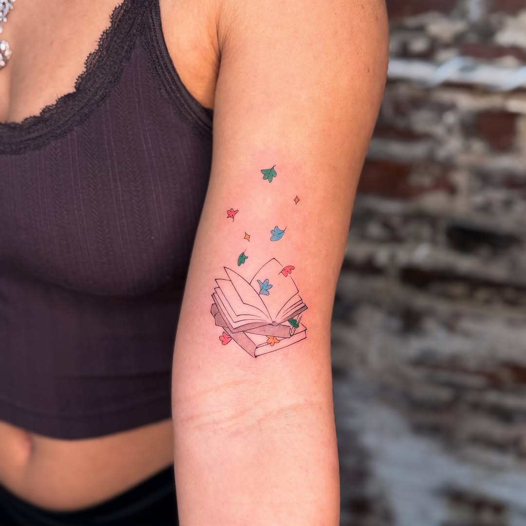Open book with flying leaves dotwork tattoo on the forearm by justin