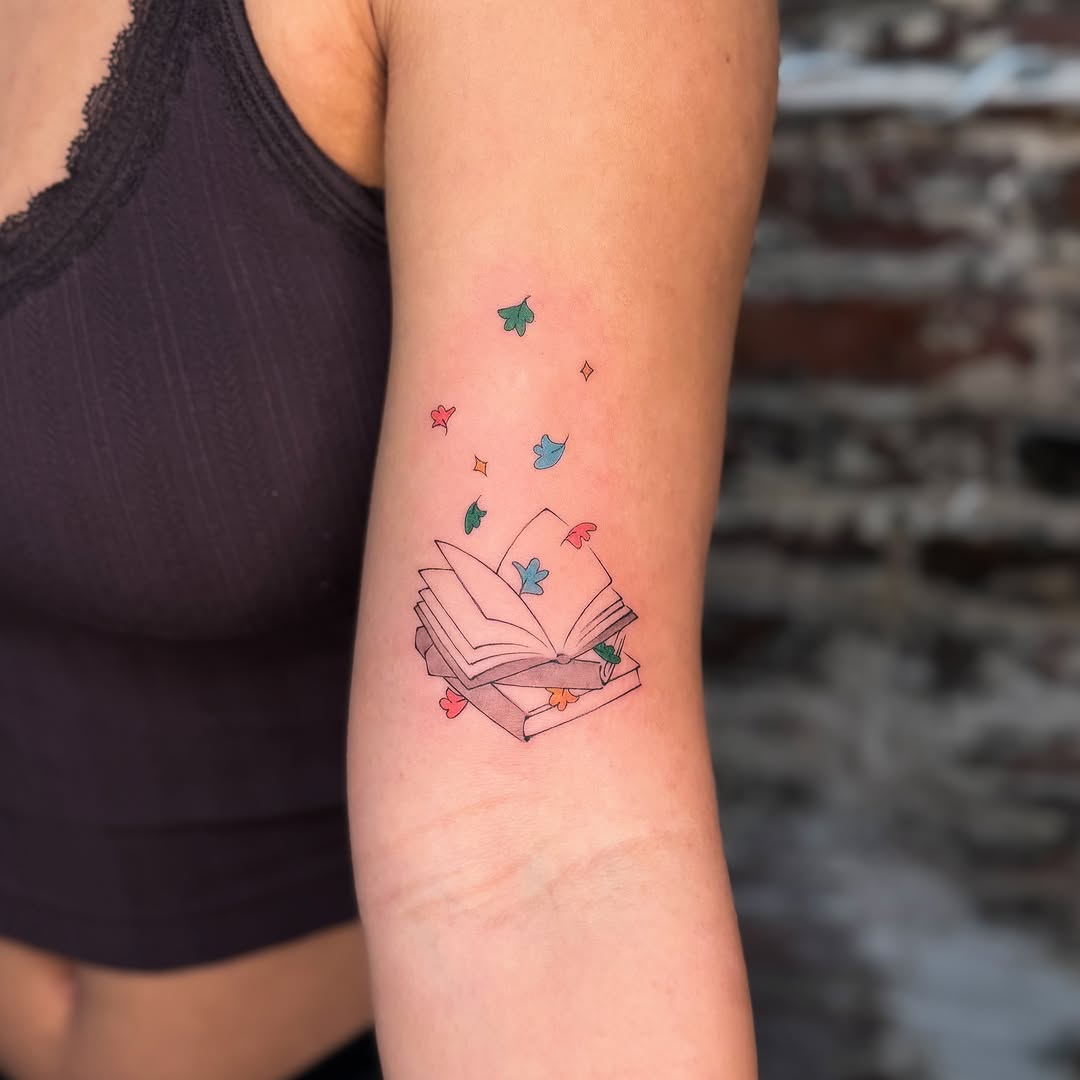 Open book with flying leaves dotwork tattoo on the forearm by justin