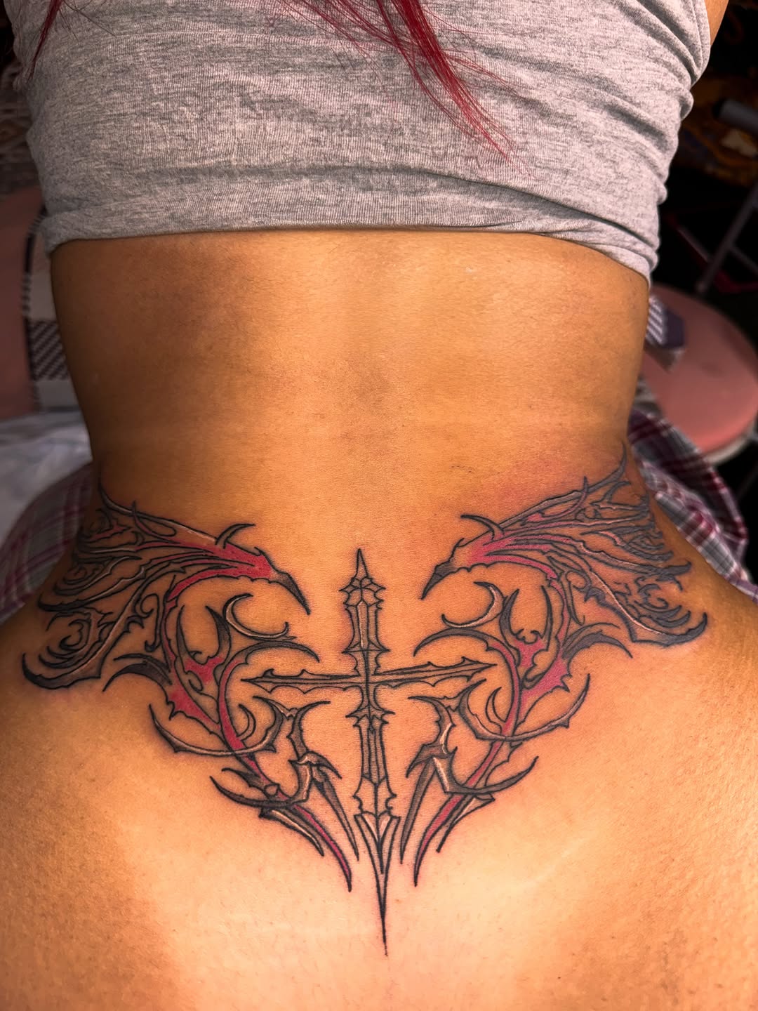Tribal cross with wings blackwork tattoo on the back by Comet