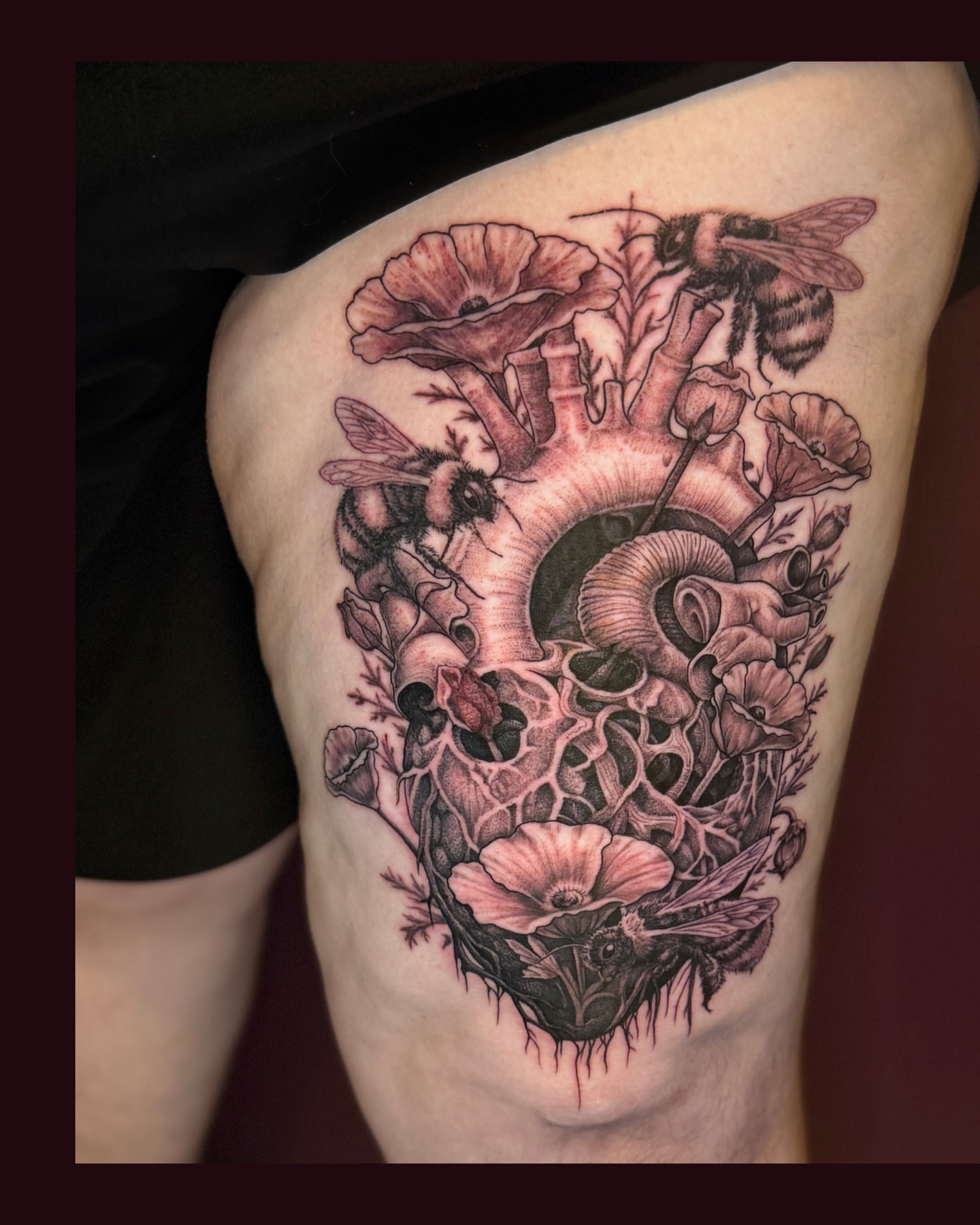 Heart with flowers and bees realism tattoo on the thigh by Eugene Oregon tattoo artist
