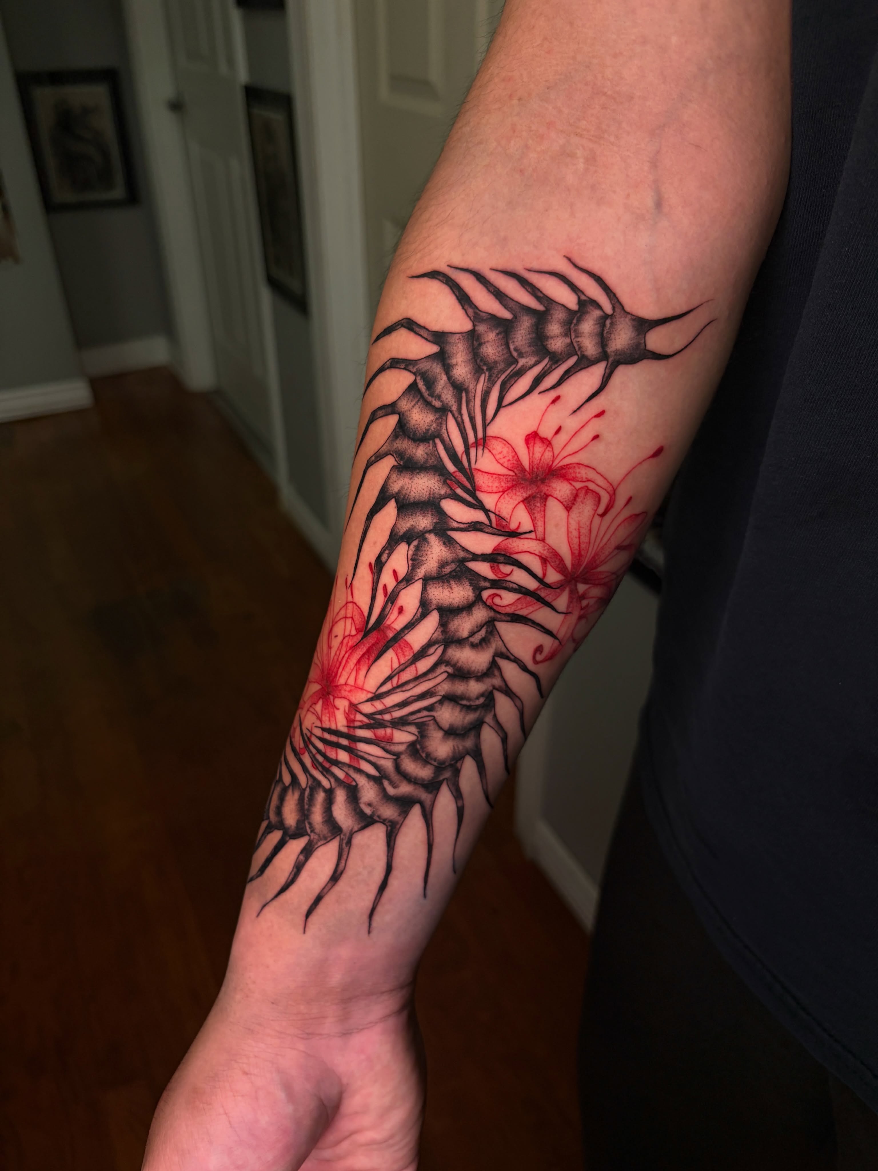 Spine and flowers realism tattoo on the forearm by Destineé