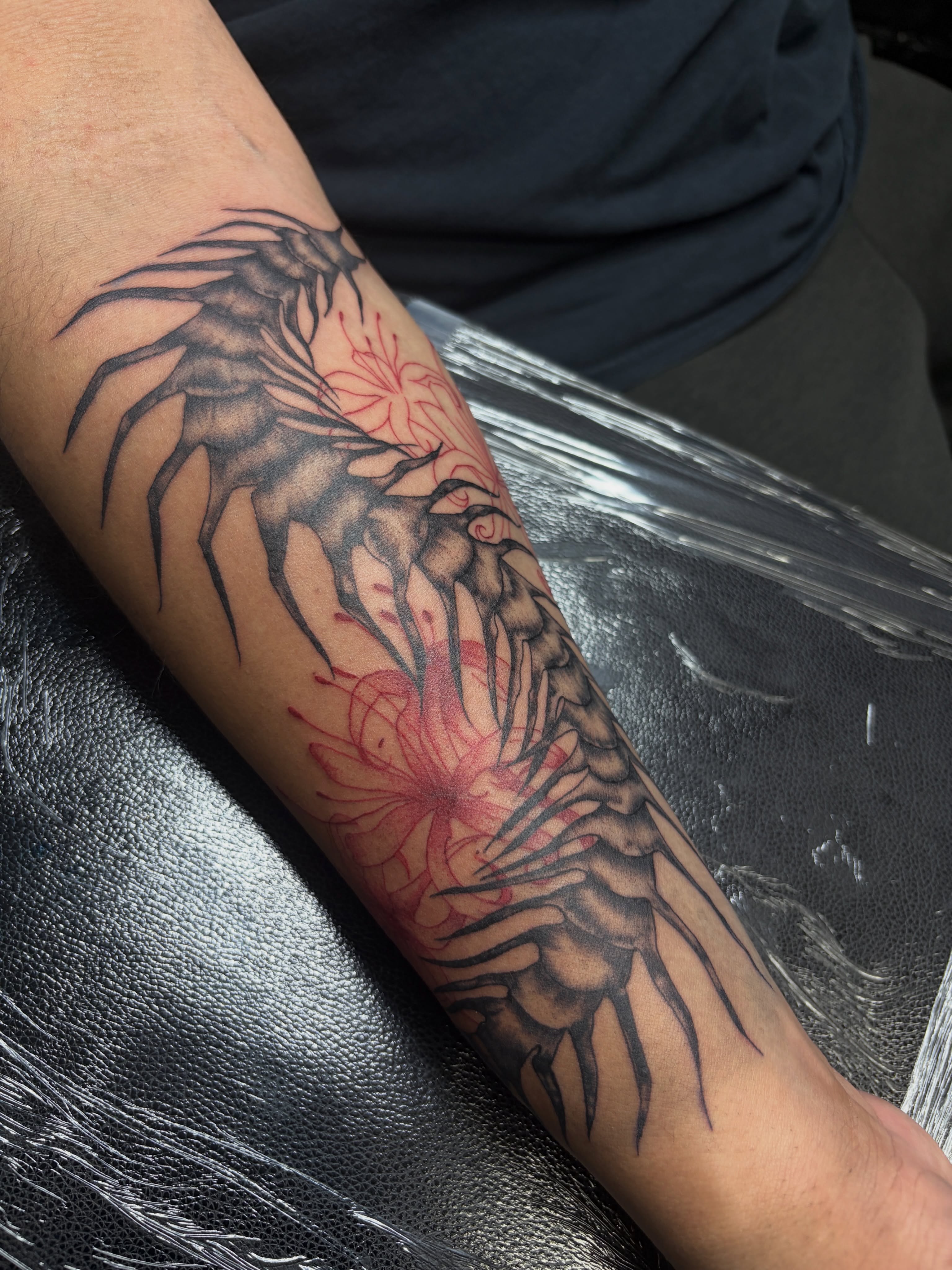 Wing and flowers black and grey tattoo on the forearm by Destineé