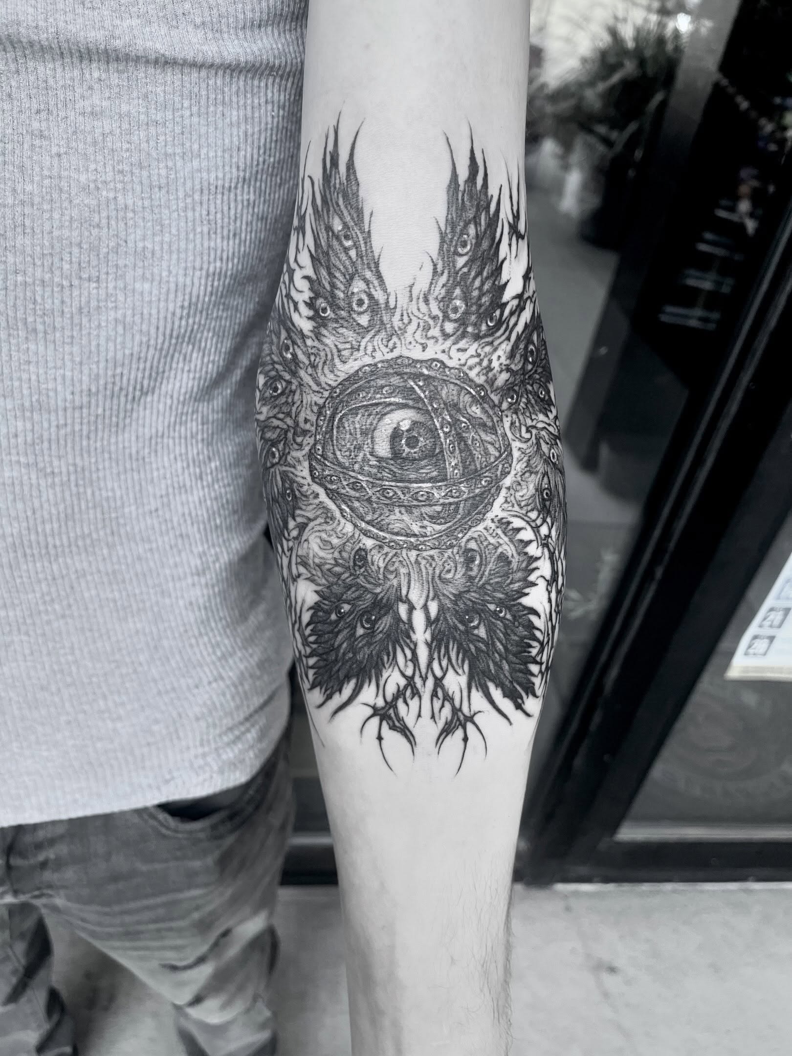 Eye with wings geometric tattoo on the forearm by Nathan Esteras