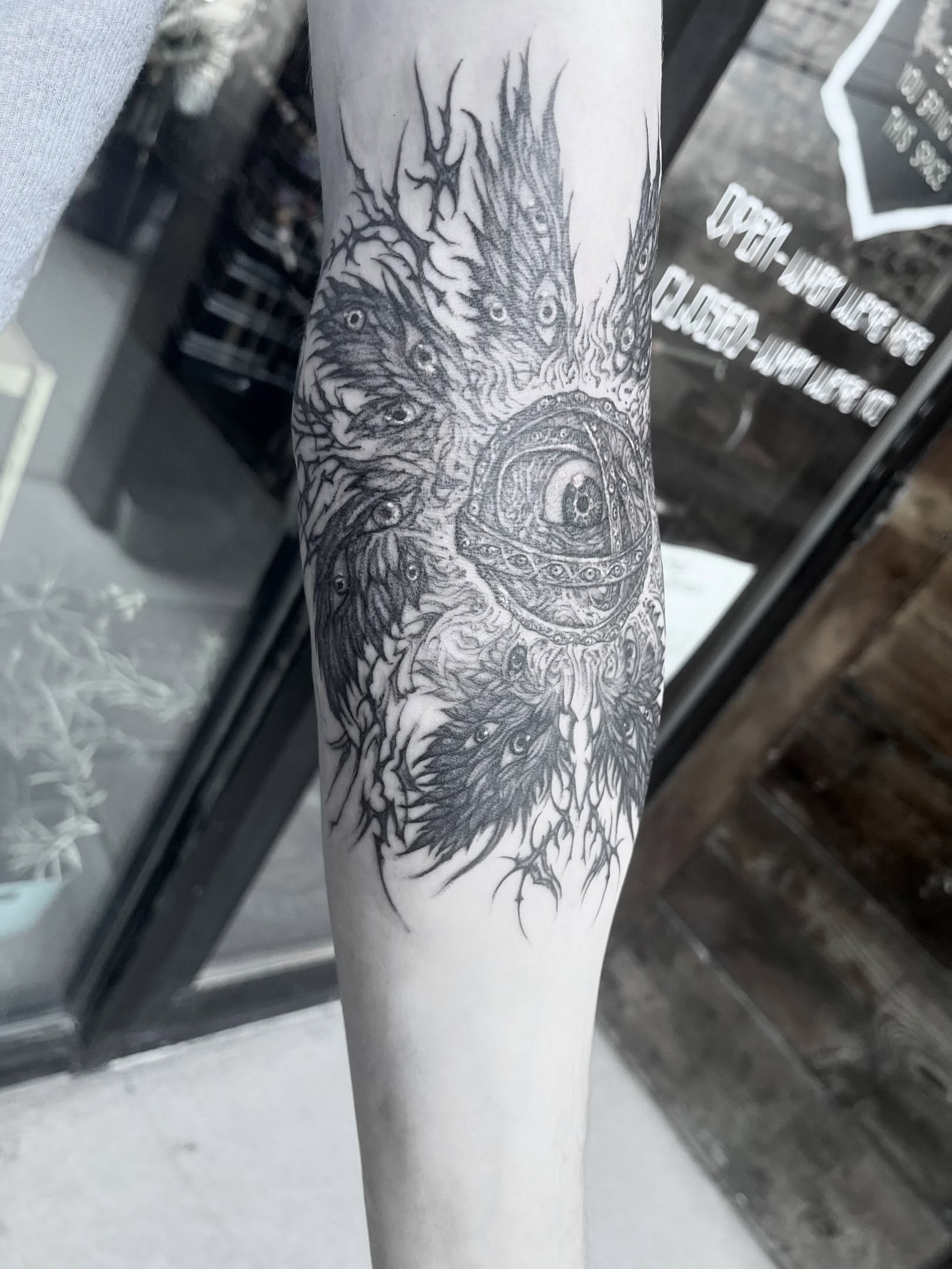 Monster dark realism tattoo on the forearm by Nathan Esteras