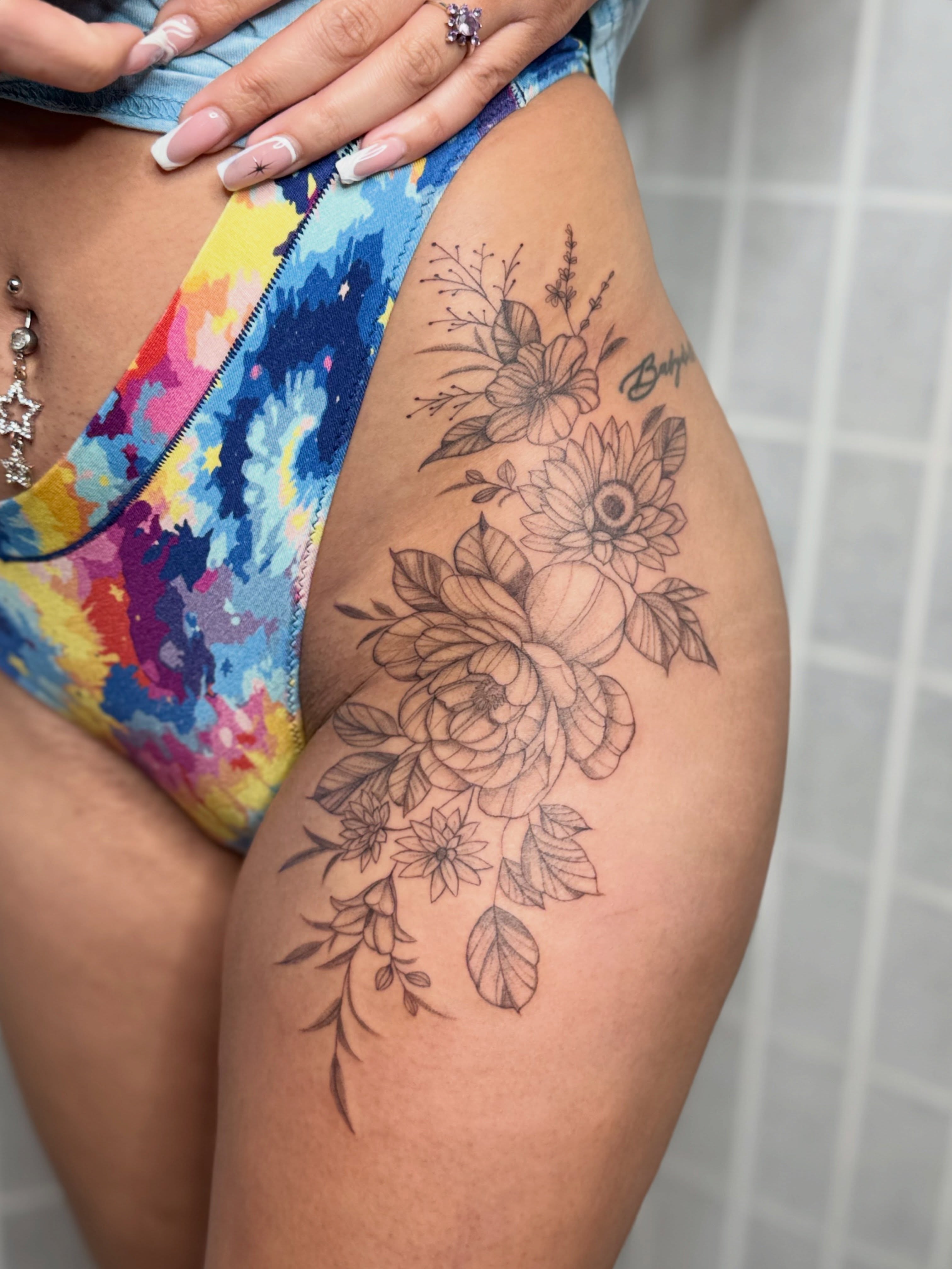 Floral bouquet black and grey tattoo on the thigh by Dama