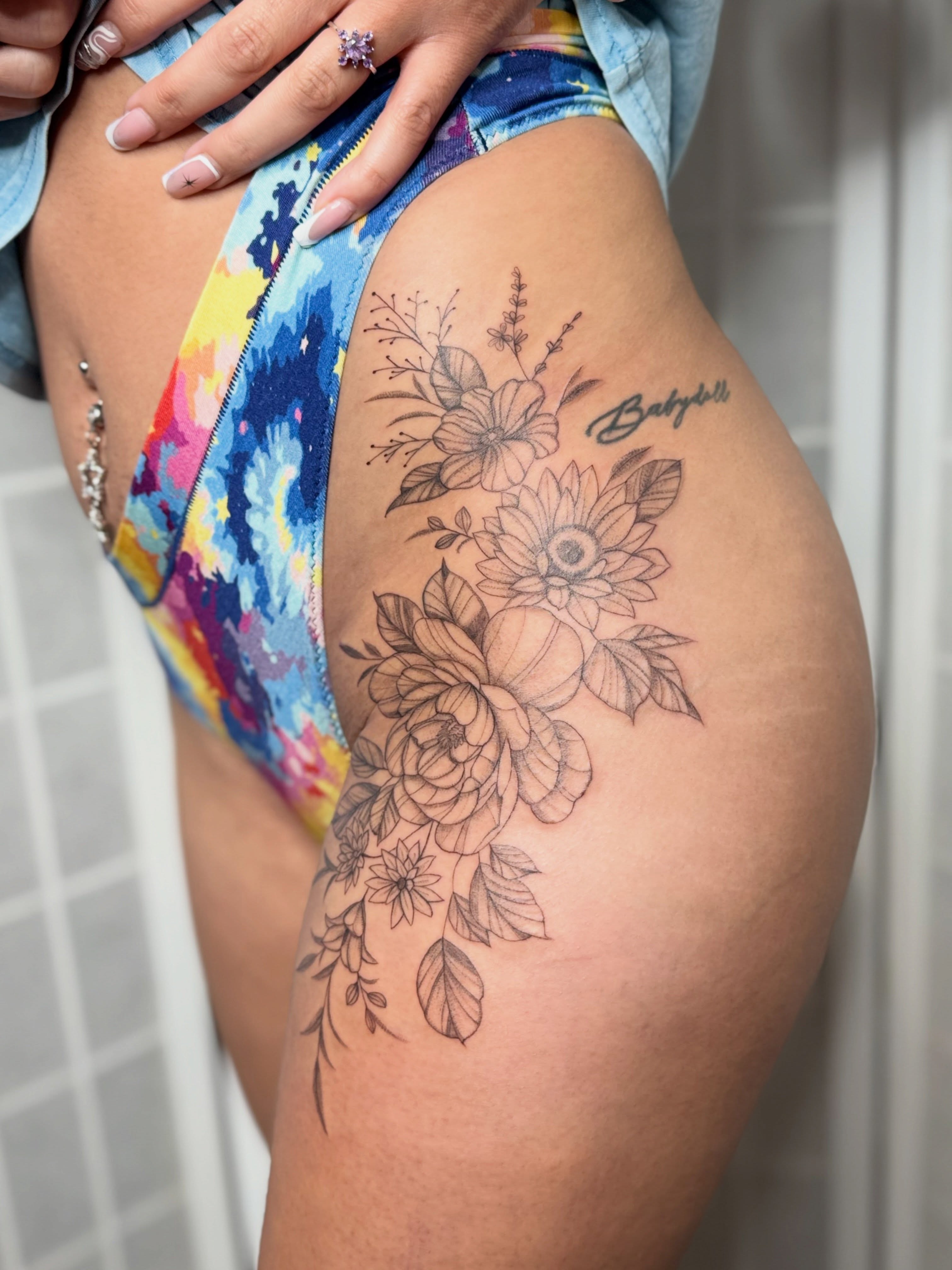 Floral bouquet black and grey tattoo on the thigh by Dama