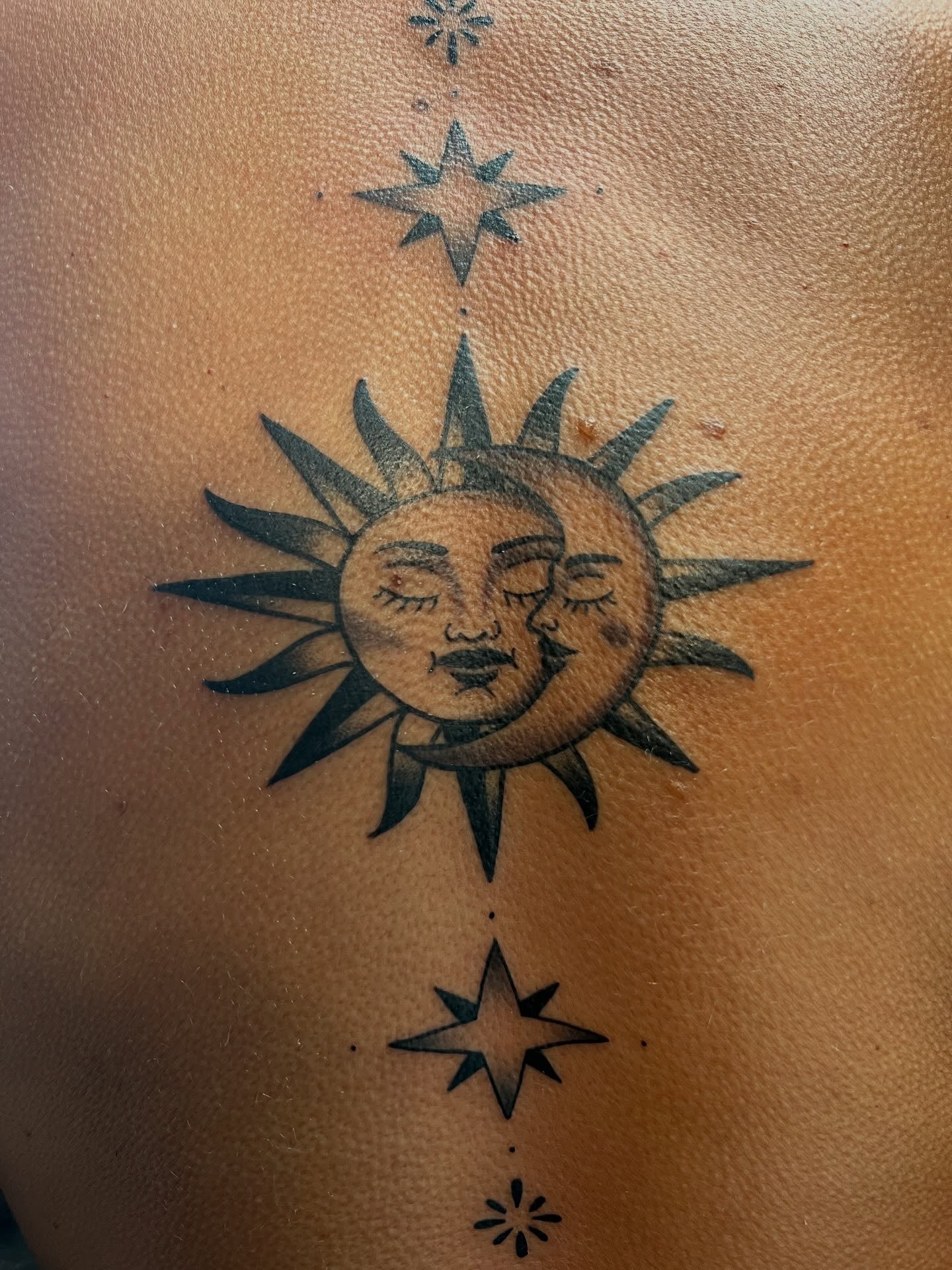 Sun and moon black and grey tattoo on the shoulder by Tyler Van Pelt