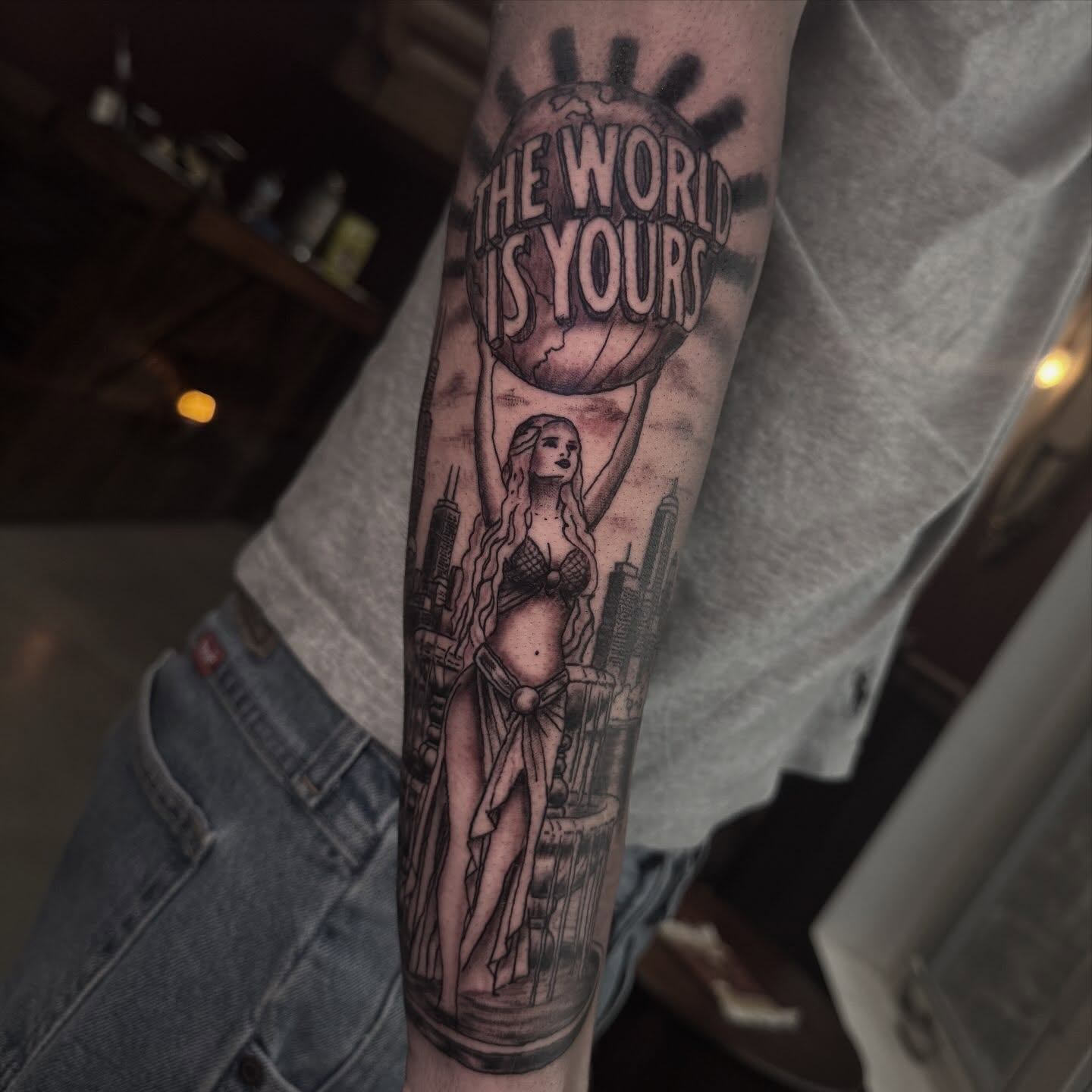 Woman holding globe realism tattoo on the forearm by Mtctattoos