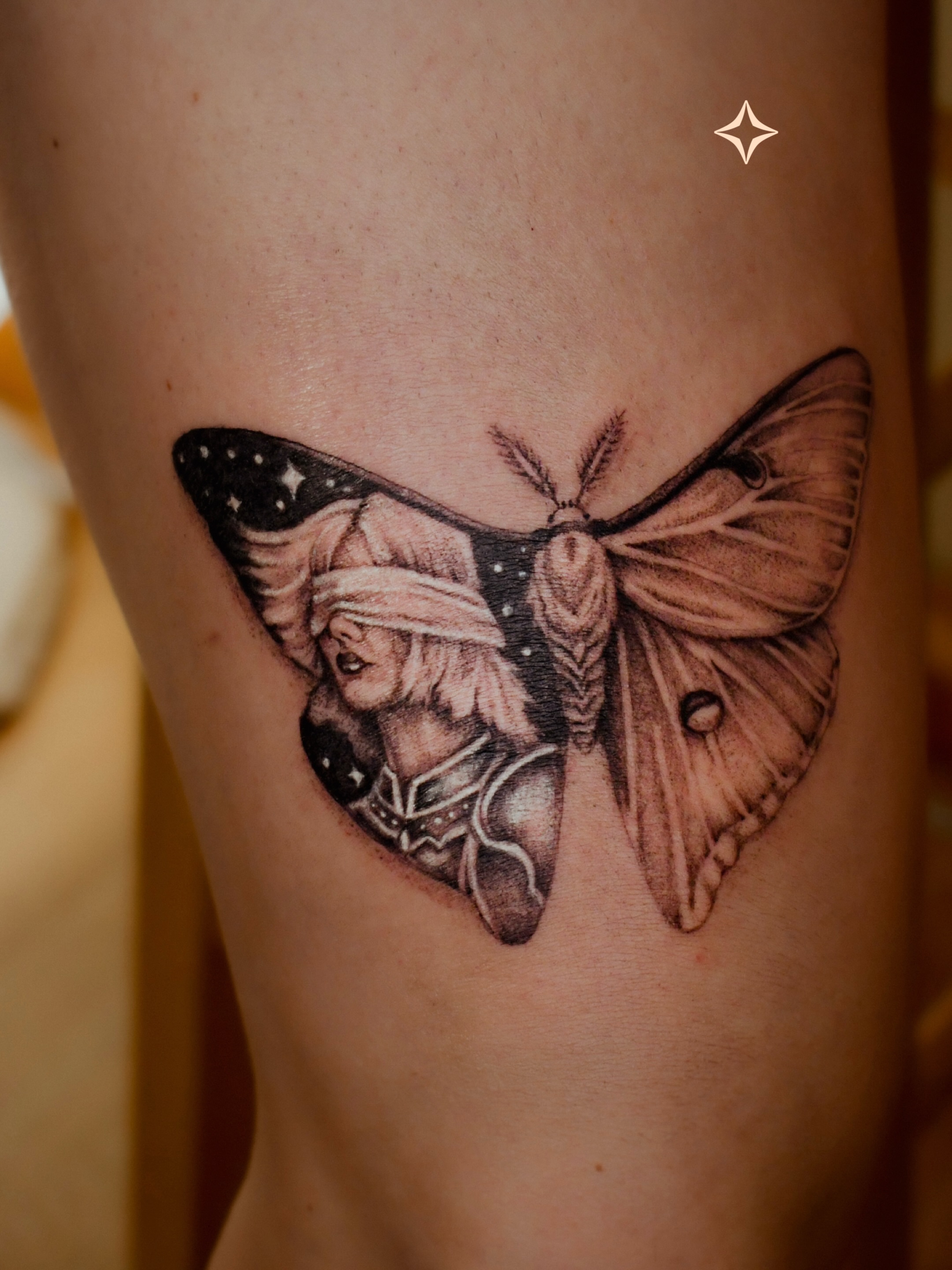 Moth with human figure realism tattoo on the thigh by 𝐇𝐚𝐫𝐩𝐞𝐫