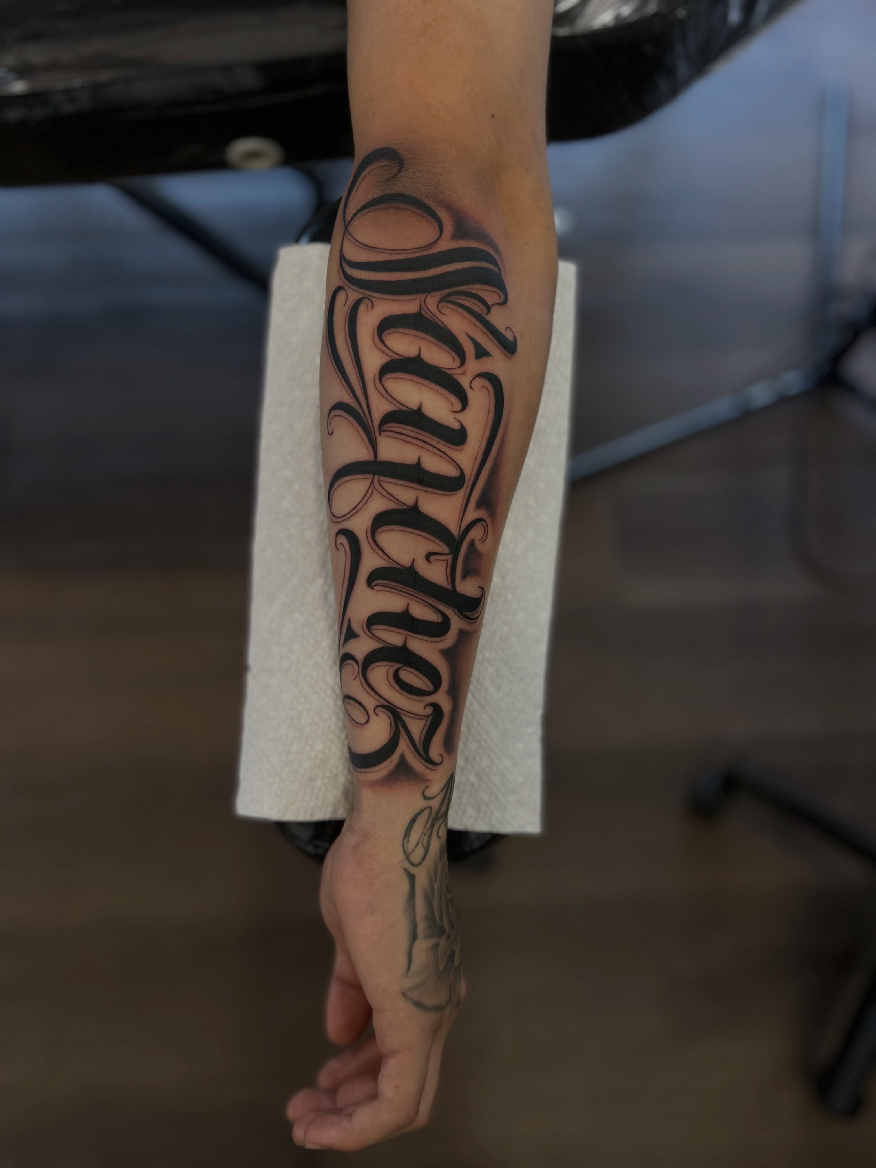 Script lettering lettering script tattoo on the forearm by Tattoo Artist
