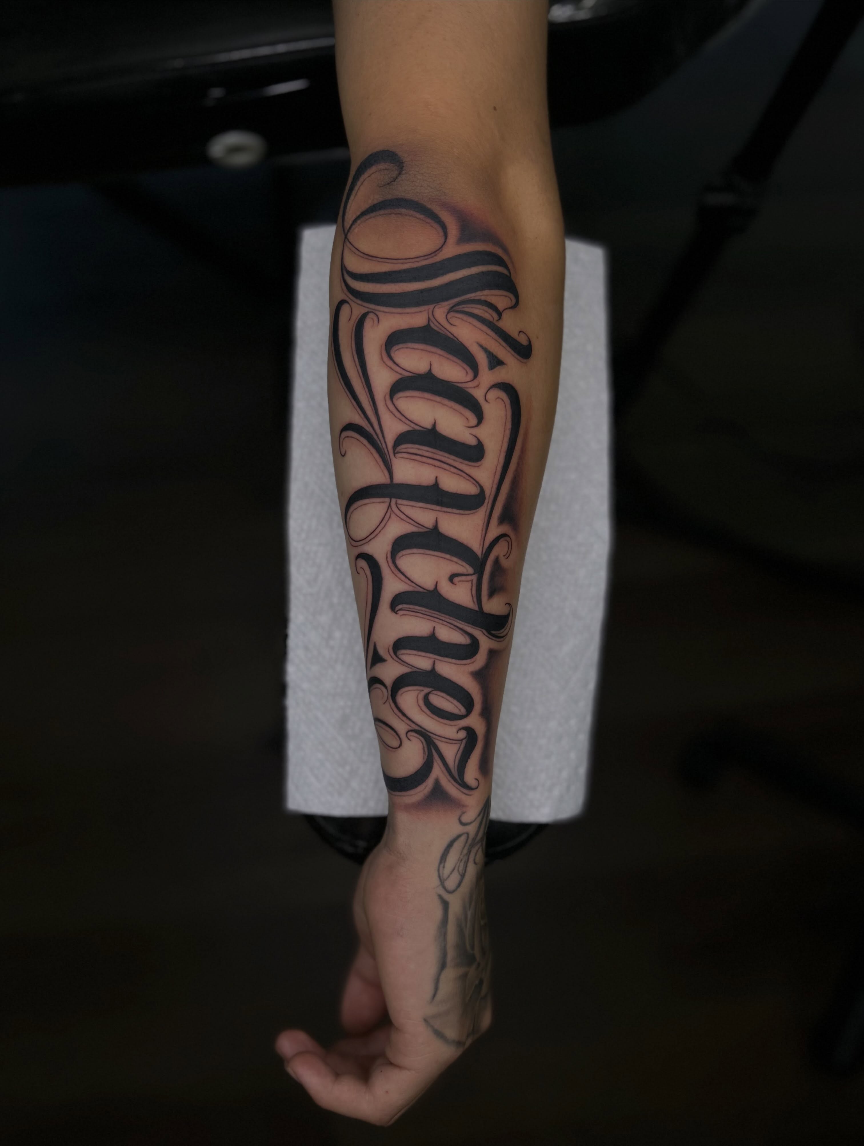 Script lettering lettering script tattoo on the forearm by Tattoo Artist