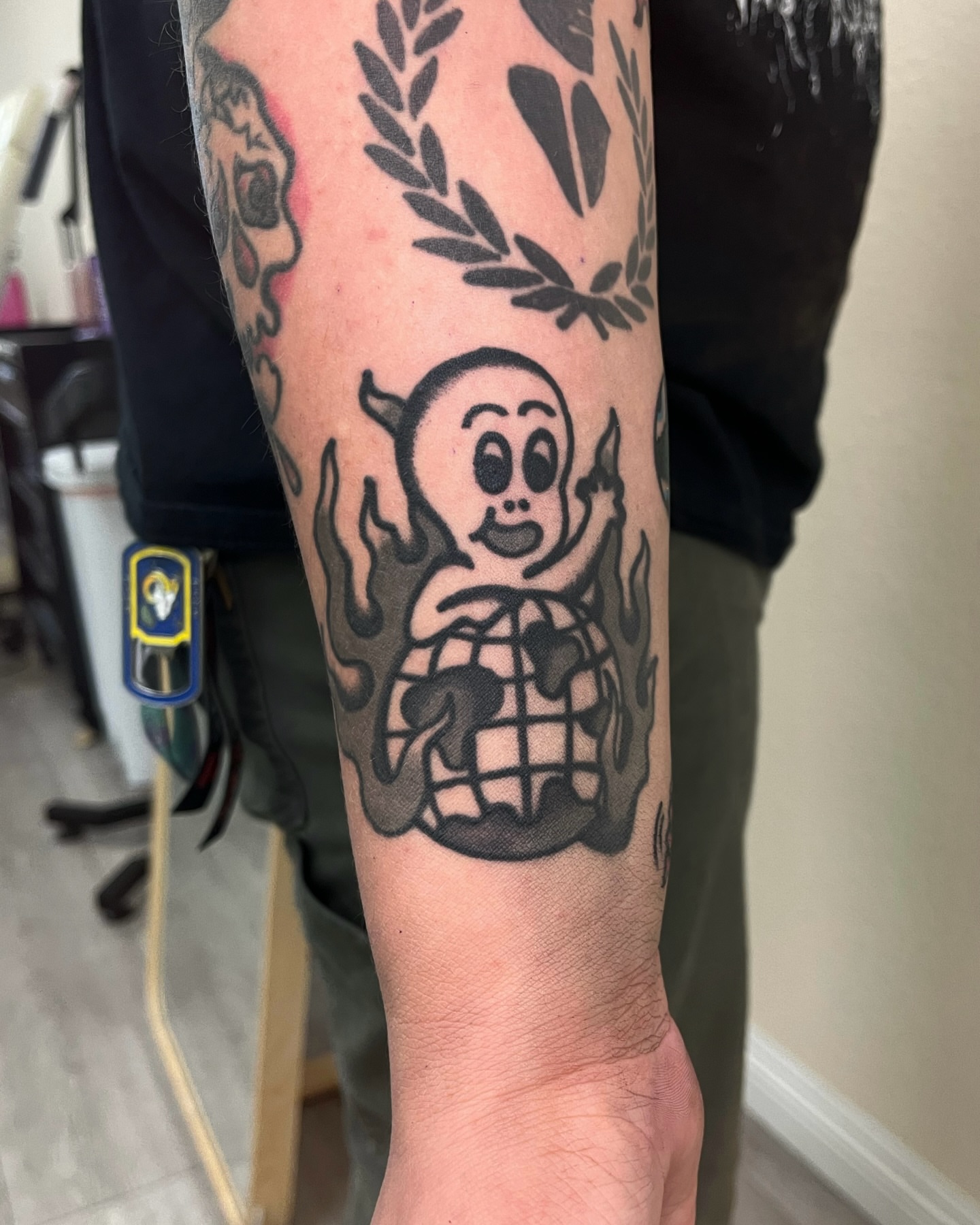Ghost holding globe black and grey tattoo on the forearm by Tattoo Dust ☻ Los Angeles
