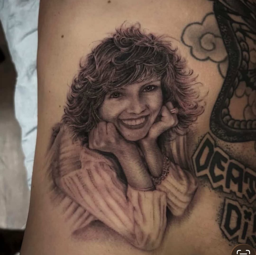 Portrait of a woman realism tattoo on the upper arm by Pat Moser