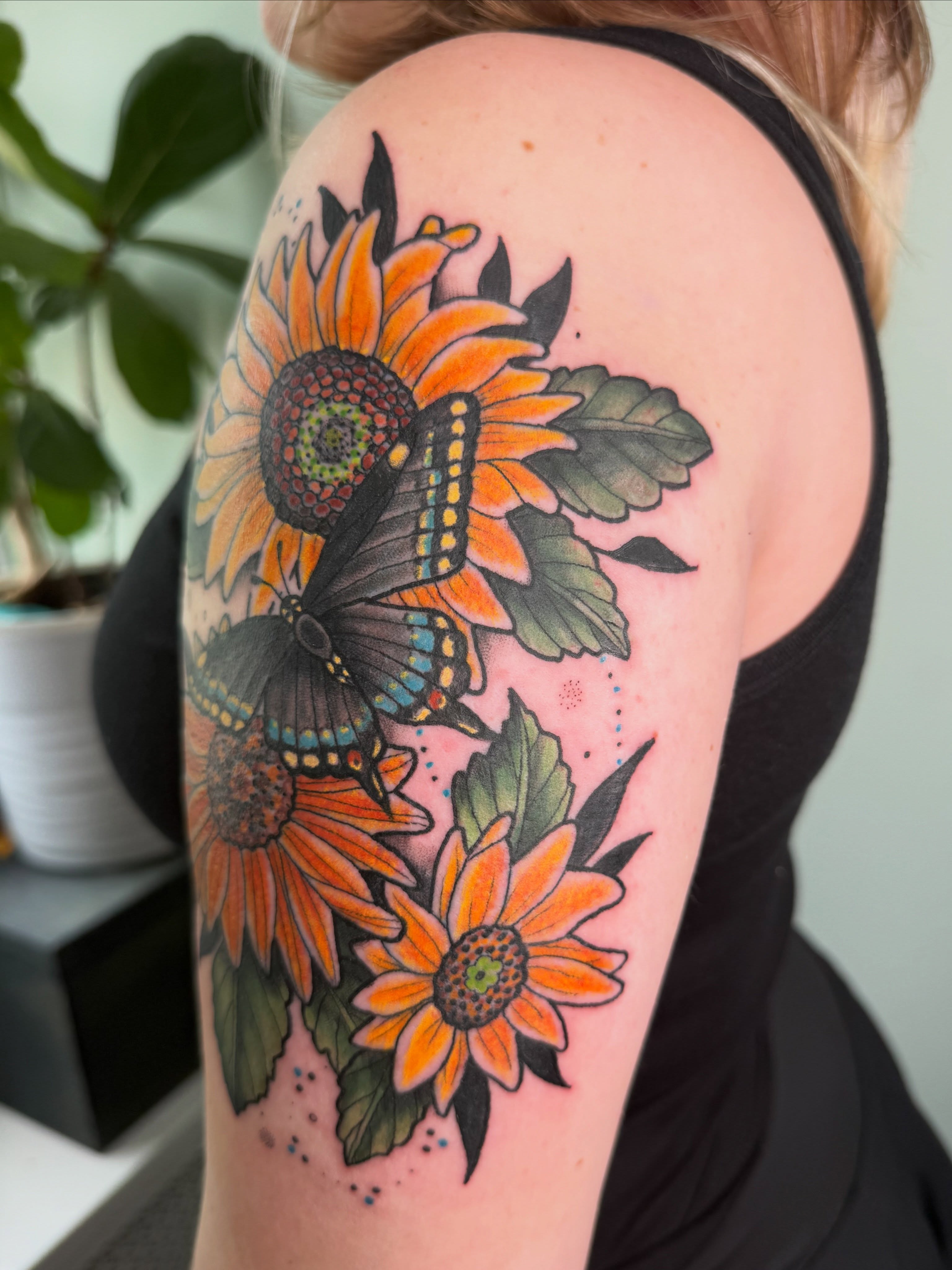 Sunflowers and butterfly dotwork tattoo on the shoulder by AJ Jensen