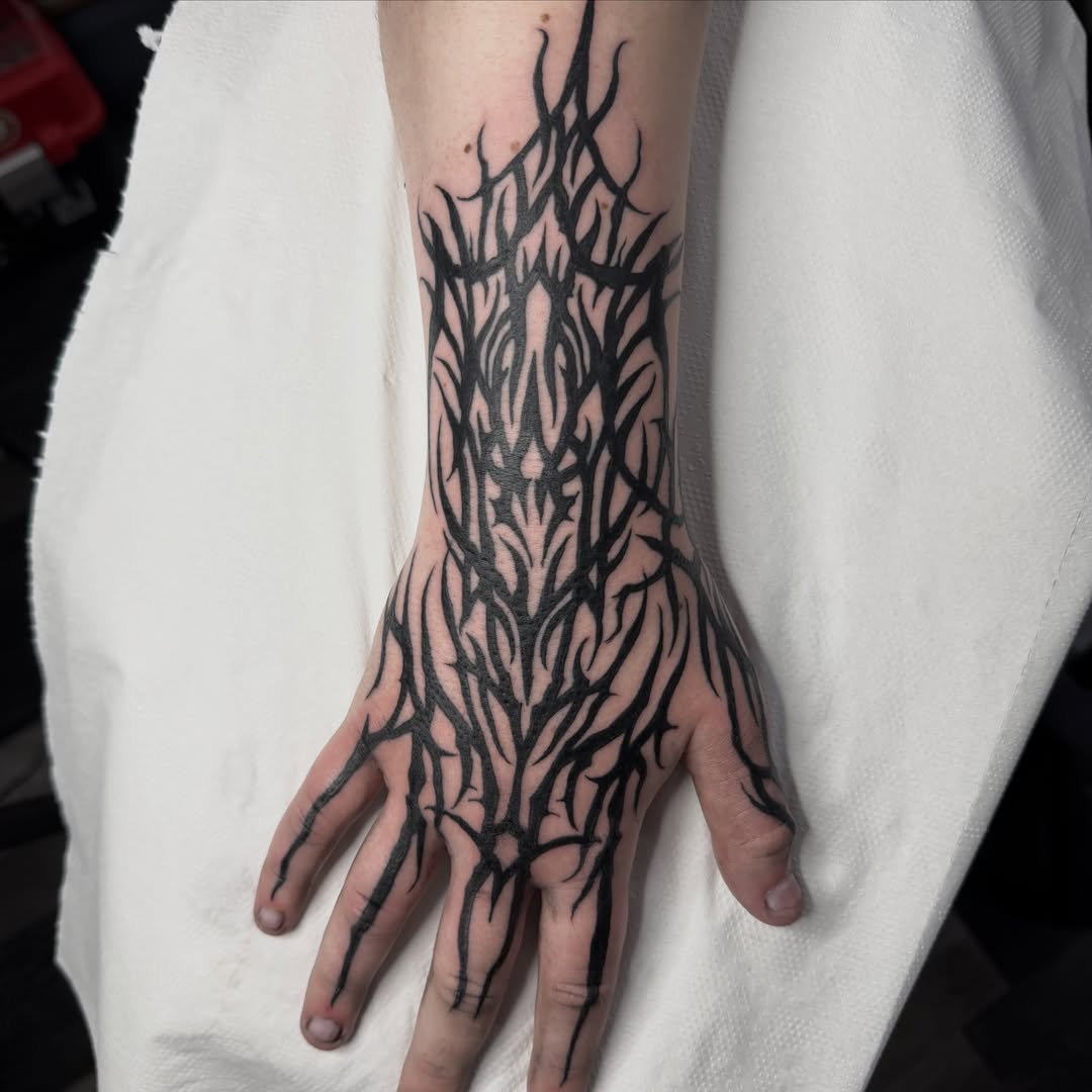 Flames blackwork tattoo on the hand by Aiden Shaw