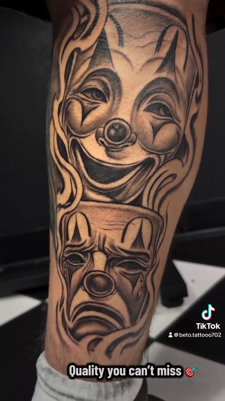 Laughing and crying clown faces realism tattoo on the forearm by Betotats