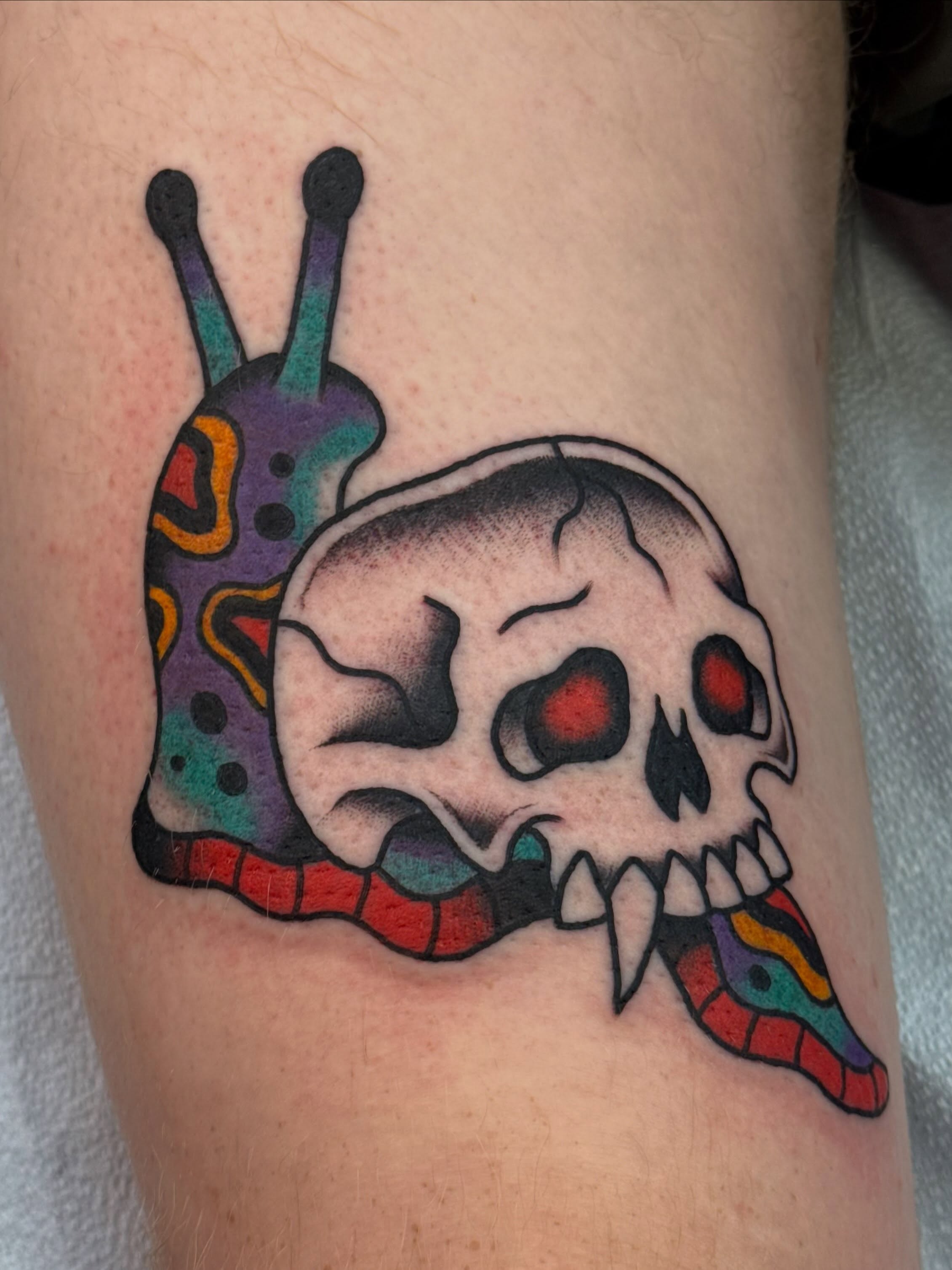 Snail skull American traditional tattoo on the thigh by Emma Eaton