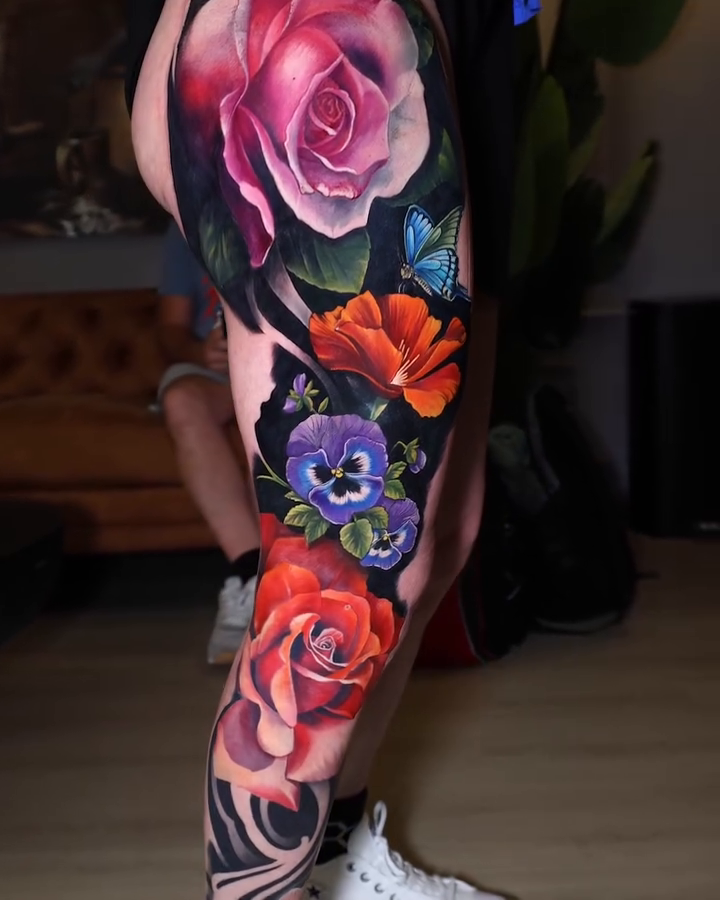 Floral arrangement with roses and pansies neo-traditional tattoo on the leg by Marek Pawlik