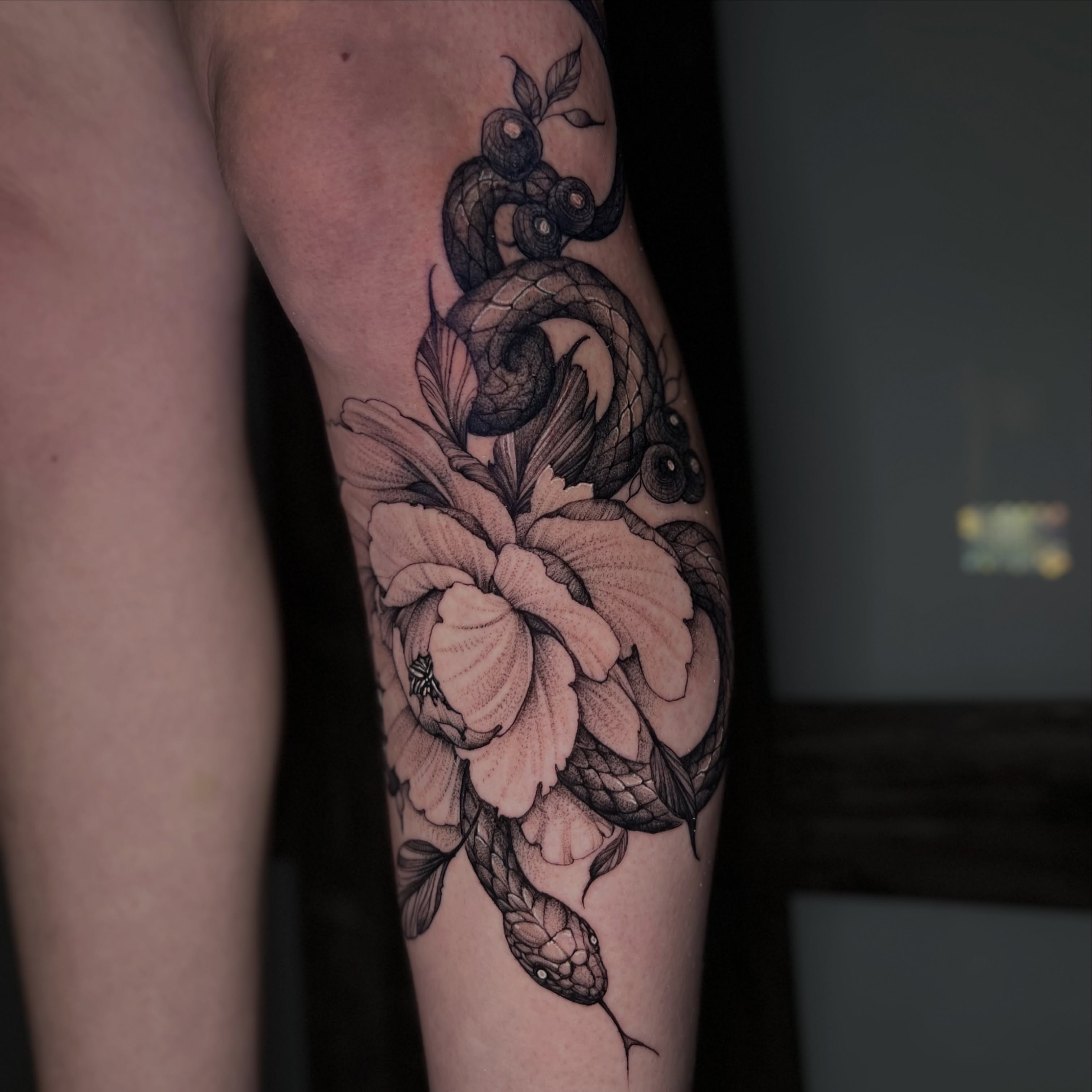 Snake and peony dotwork tattoo on the forearm by Dominick Cali, East Islip, New York