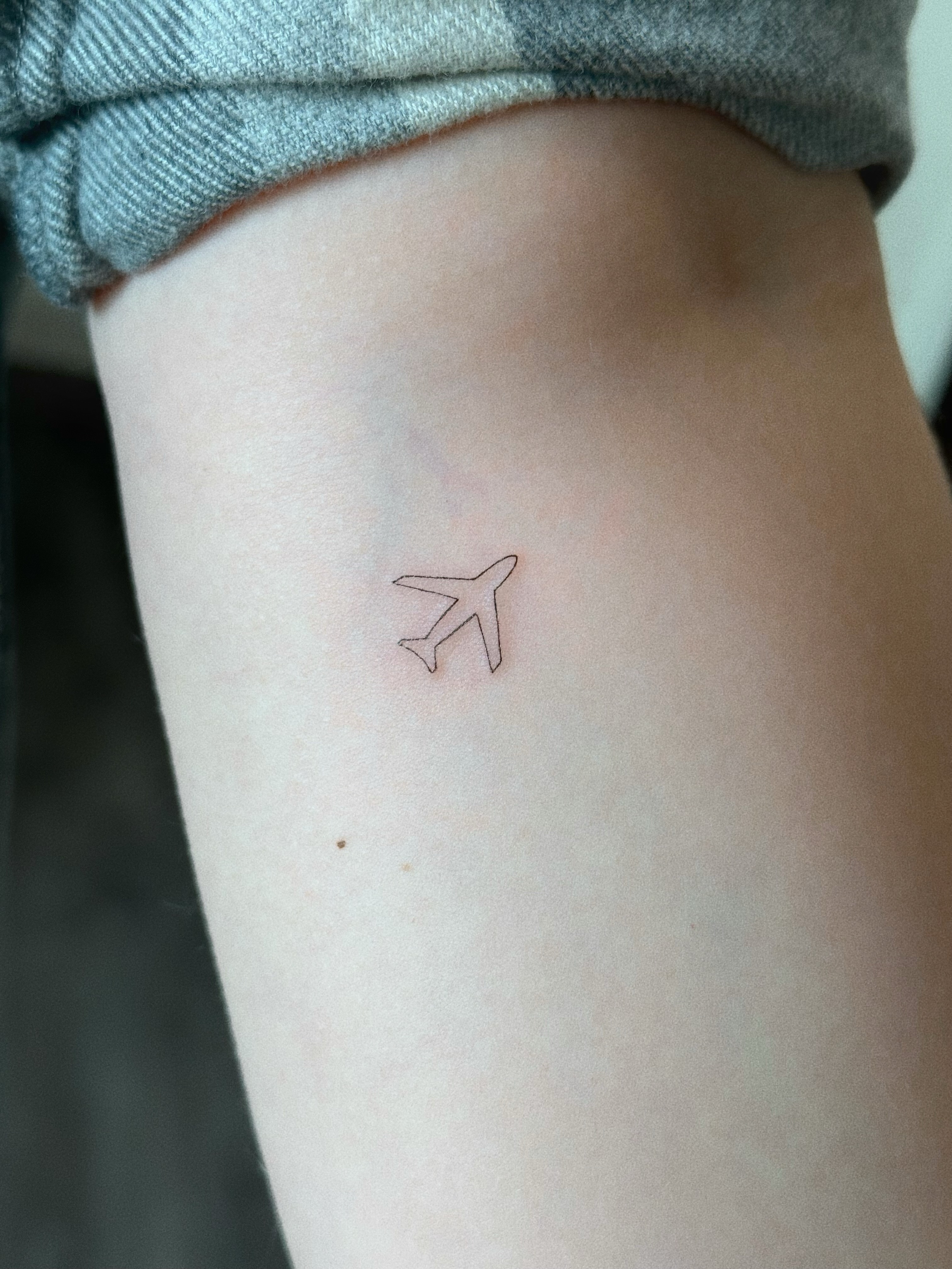 Airplane minimalist tattoo on the forearm by Victoria