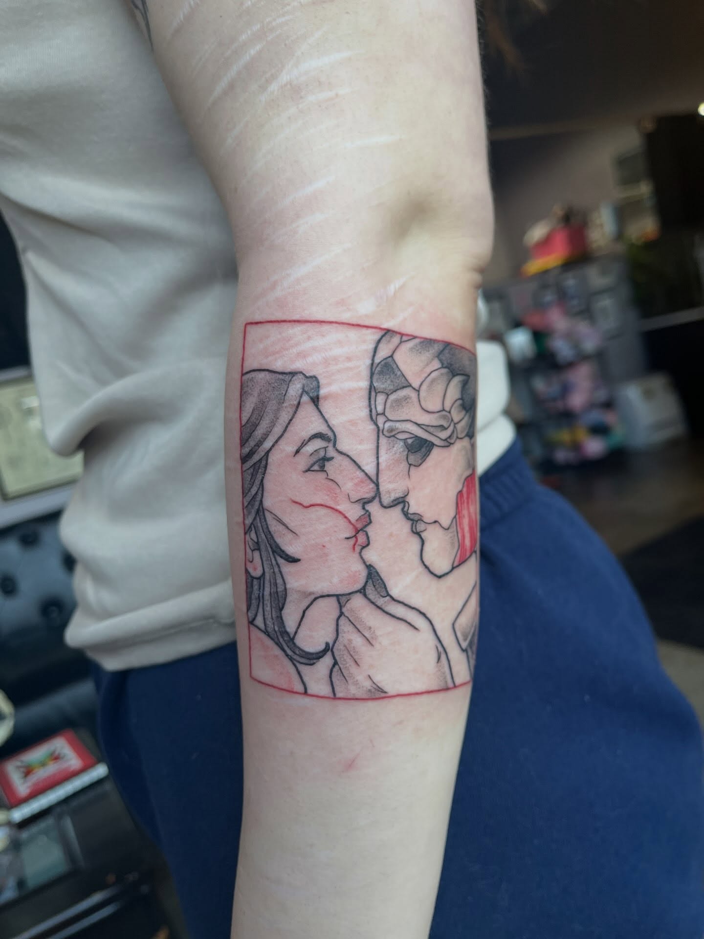 Couple kissing neo-traditional tattoo on the forearm by bunny, Minneapolis, Minnesota