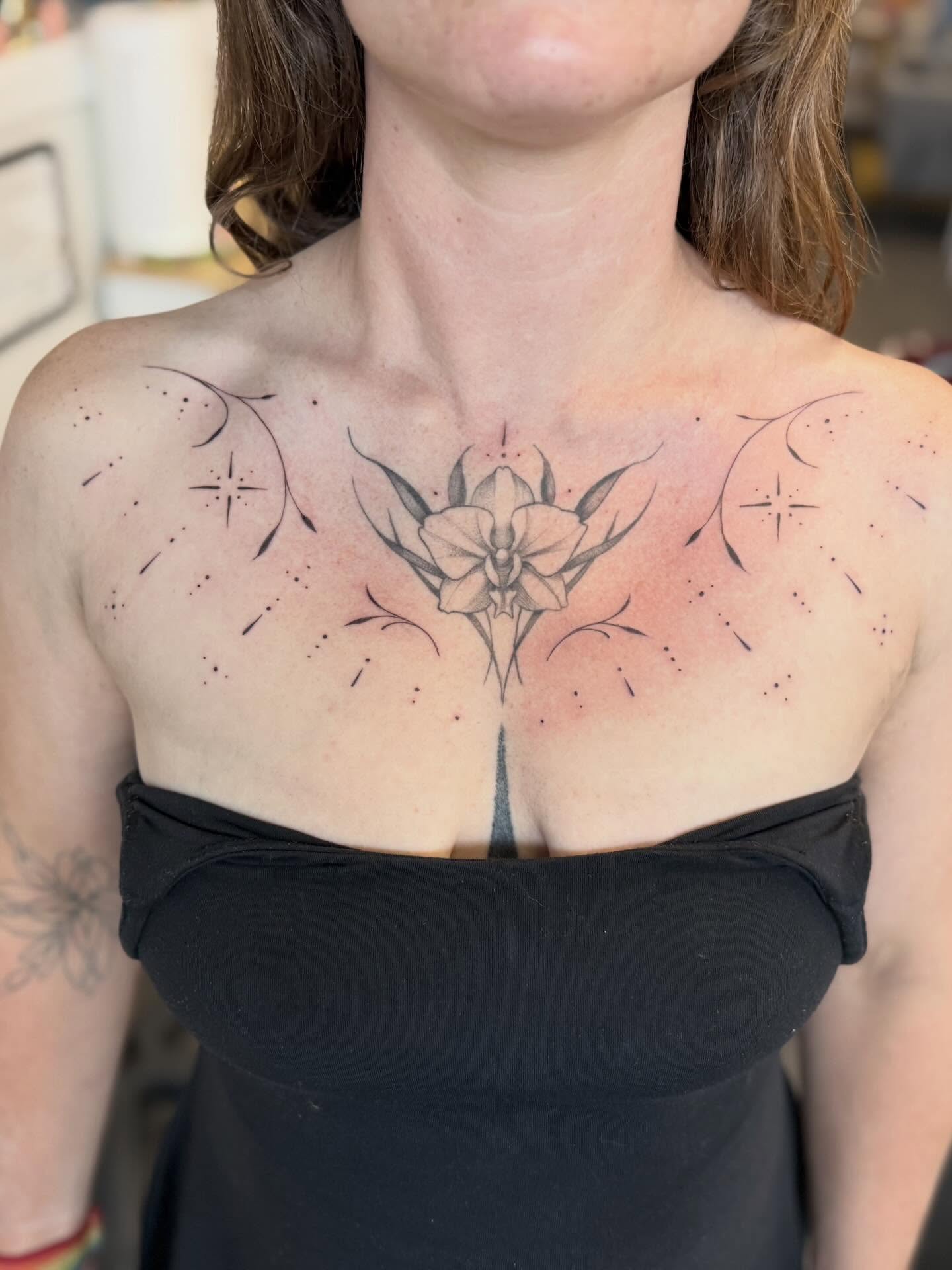 Orchid dotwork tattoo on the chest by Peter Harren