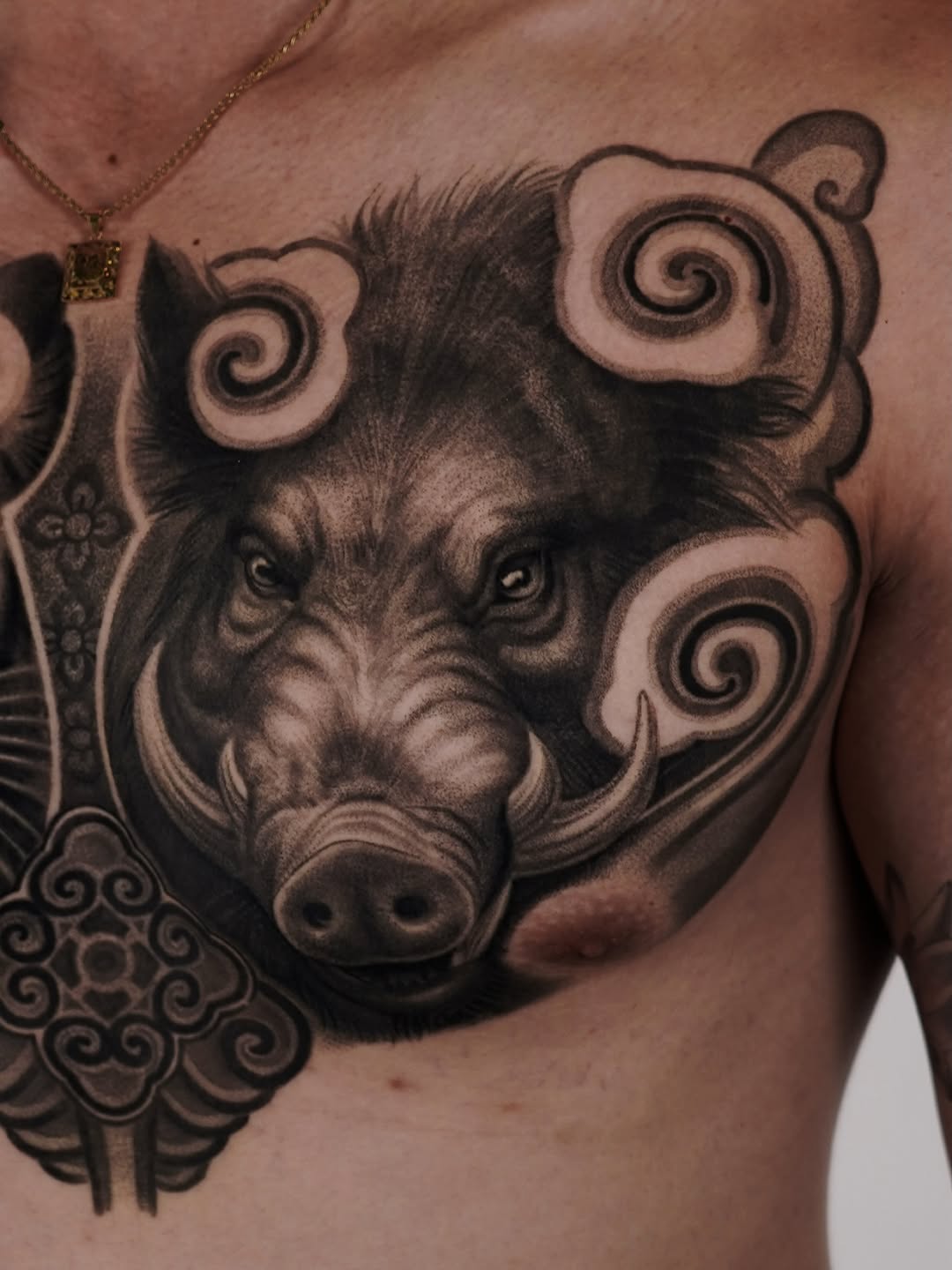 Wild boar head with clouds realism tattoo on the chest by Enrique Martinez