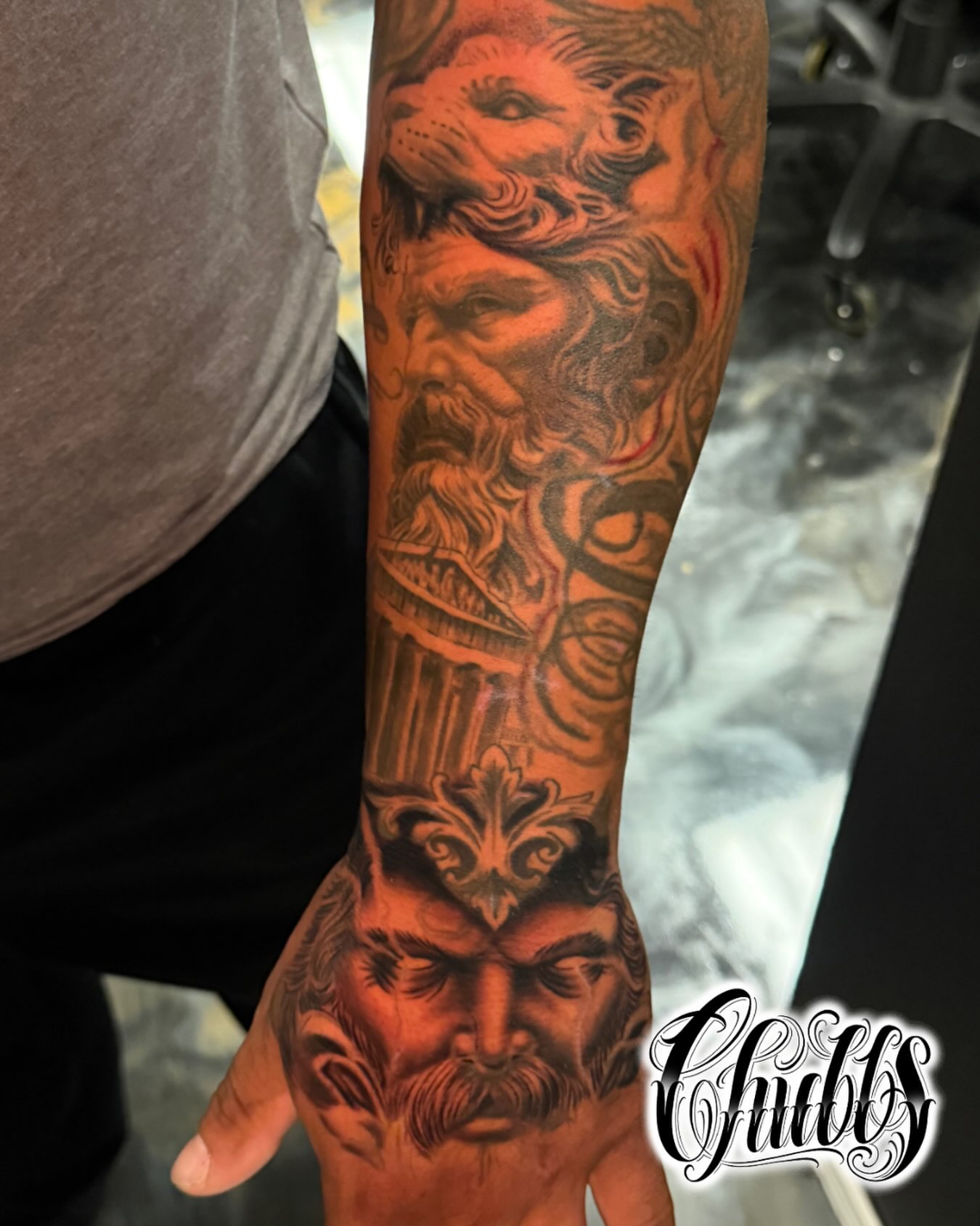 Bearded man with lion realism tattoo on the forearm by Chubbs