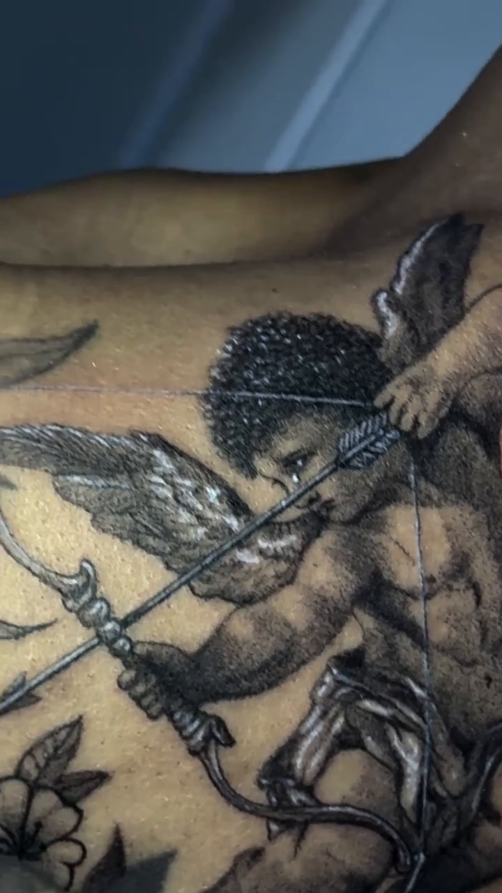 Cherub with bow and arrow realism tattoo on the shoulder by Raciel Fabian Romero