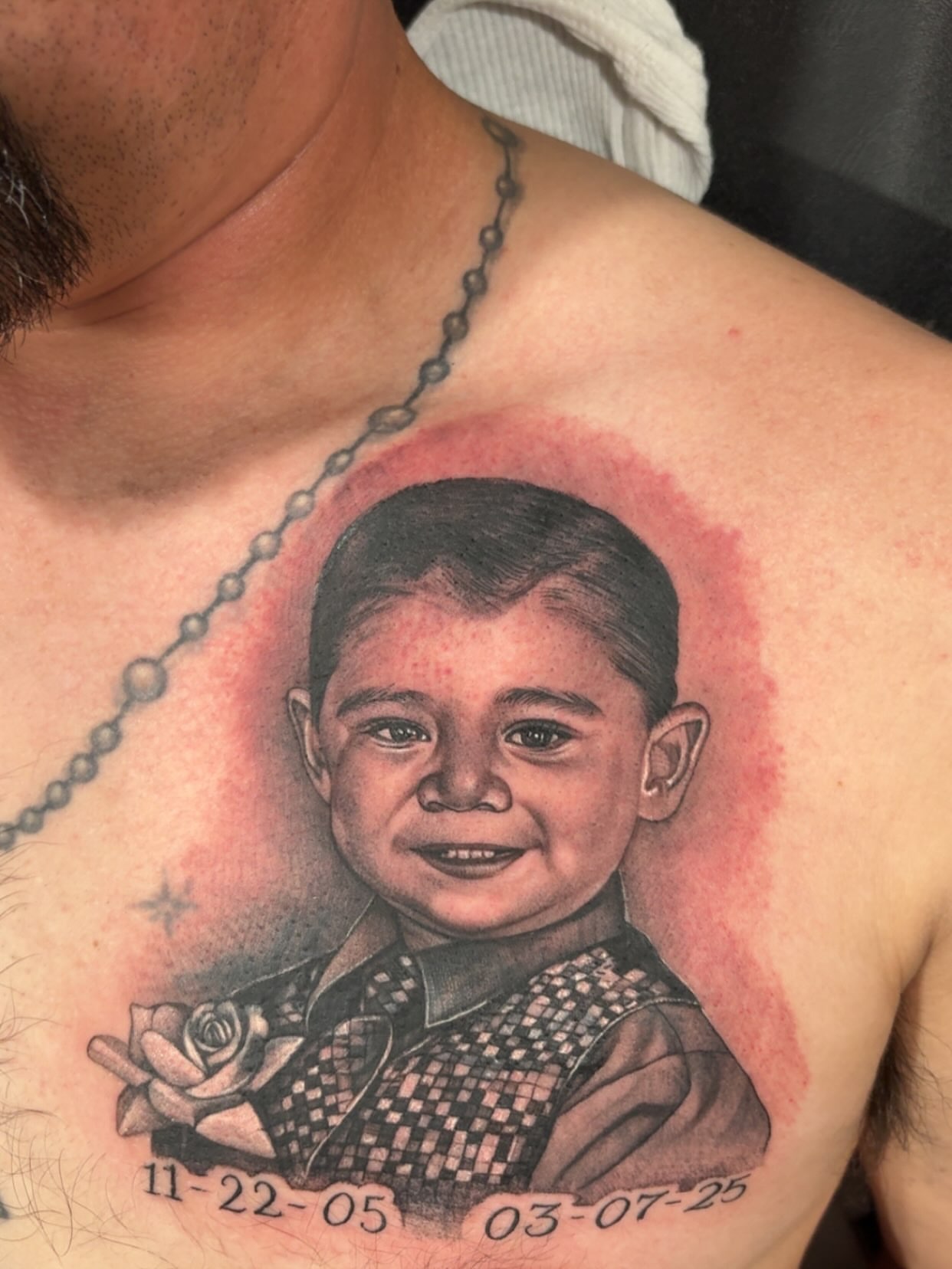 Child portrait realism tattoo on the chest by Juan Lira
