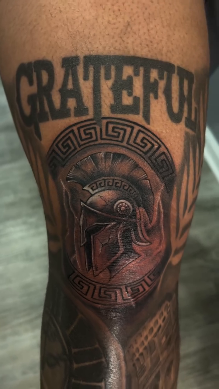 Spartan helmet with 'Grateful' text realism tattoo on the forearm by Oto_art