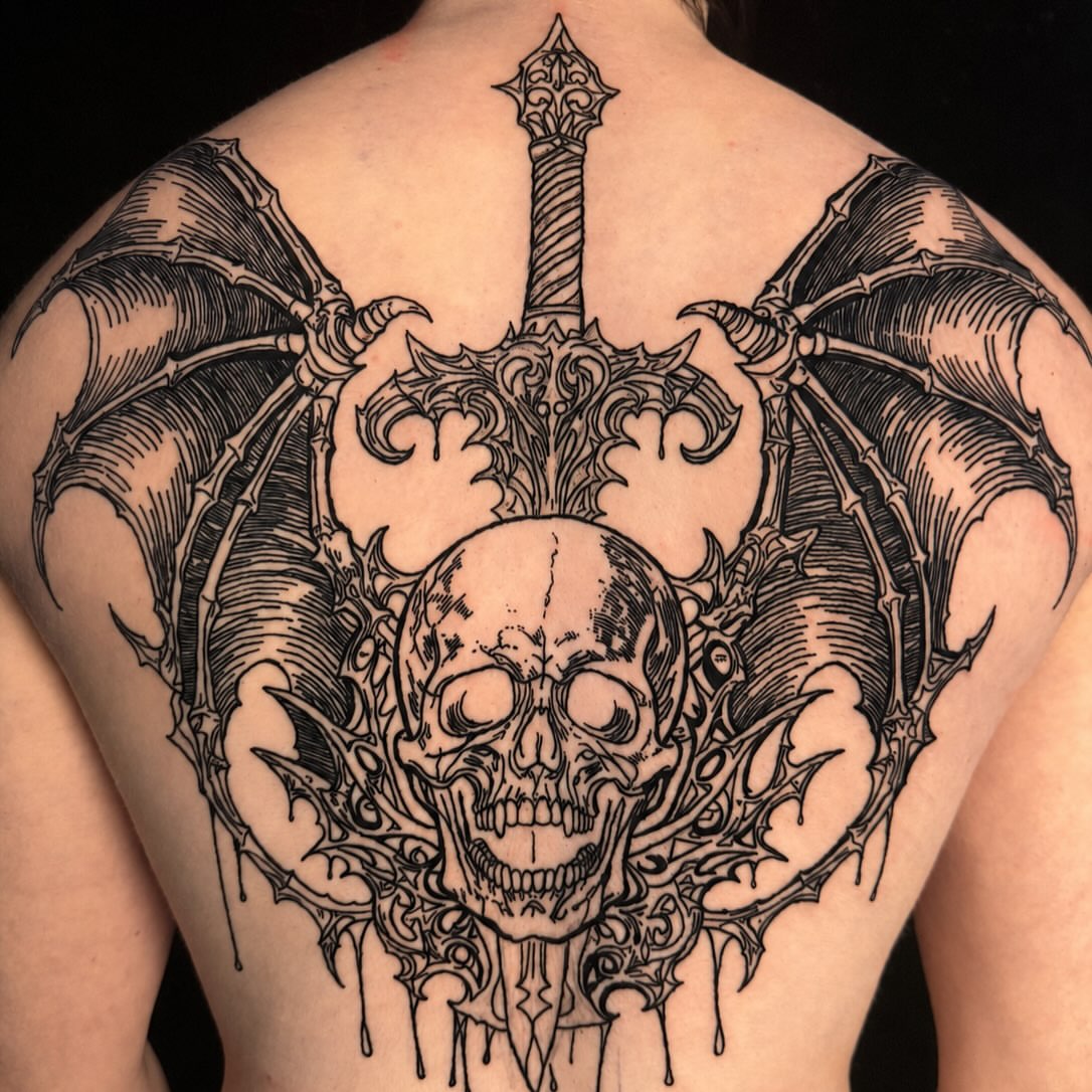 Skull and bat wings dark realism tattoo on the back by Brandiane Wells
