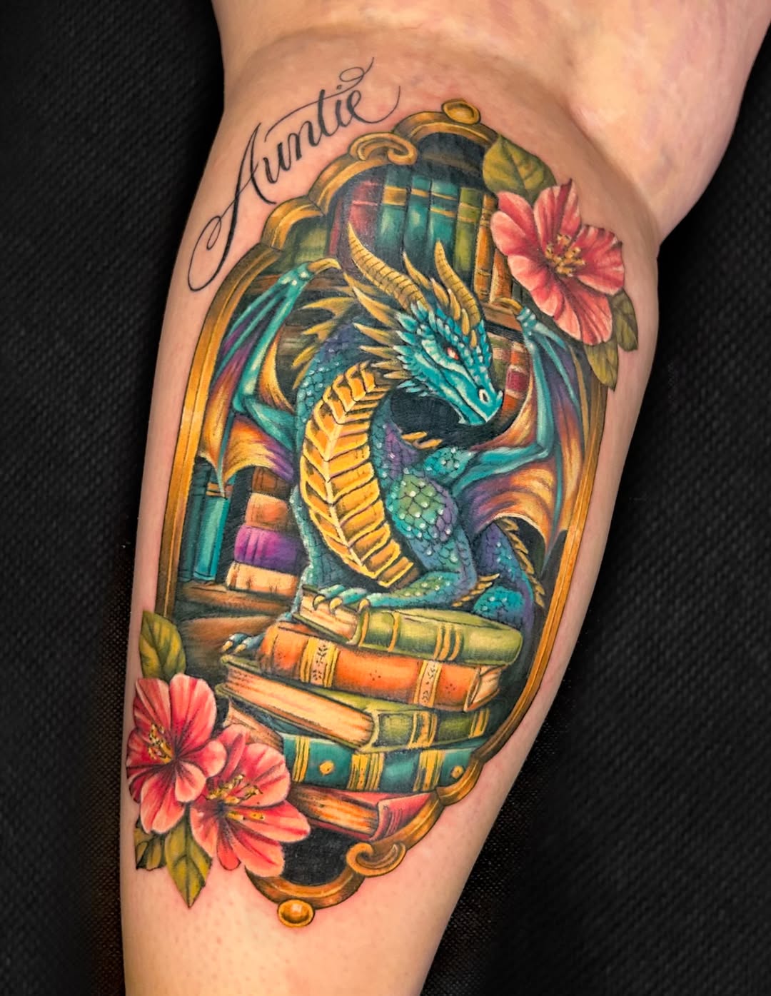 Dragon on books with flowers watercolor tattoo on the forearm by Kim Goff - Special K