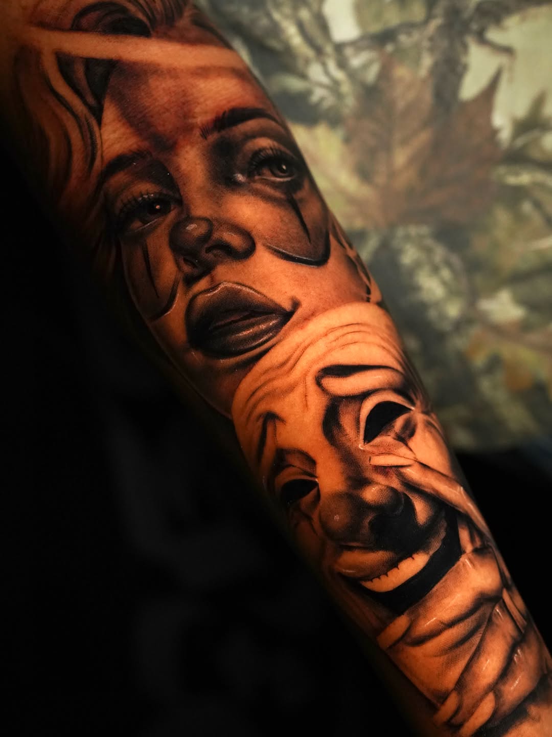 Two faces, one sad, one smiling realism tattoo on the forearm by Jennifer Garcia