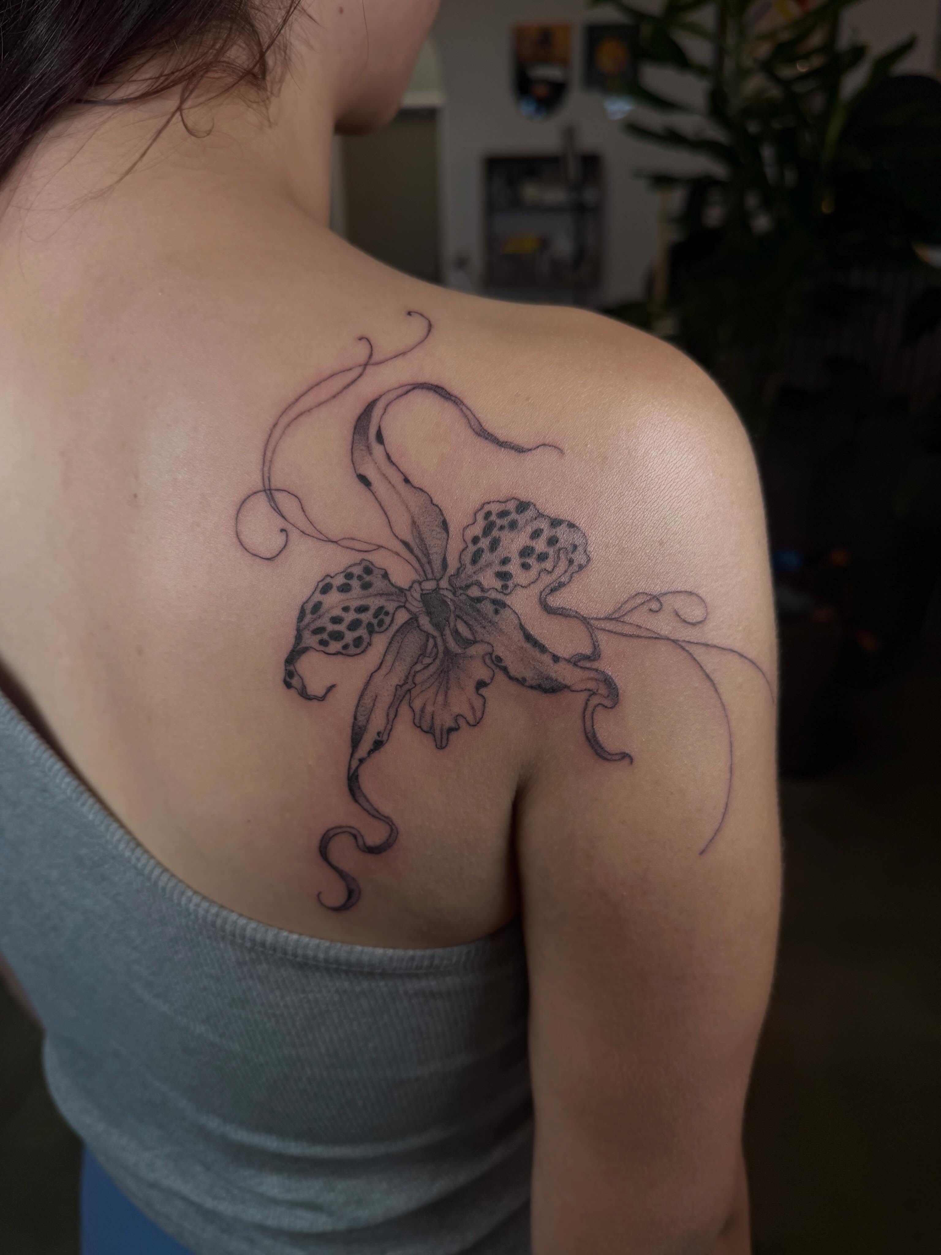 Orchid black and grey tattoo on the shoulder by Lxx.