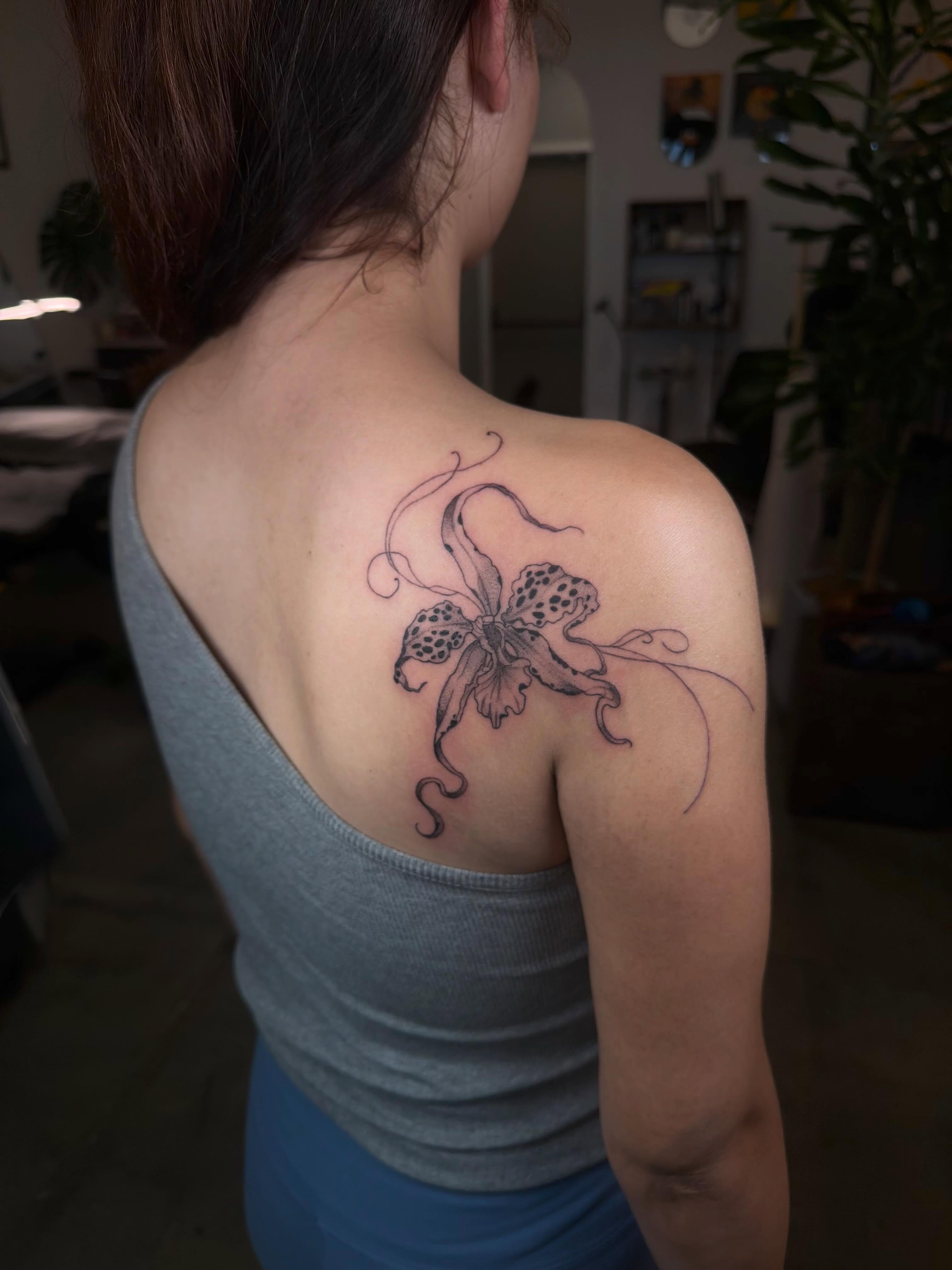 Orchid black and grey tattoo on the shoulder by Lxx.