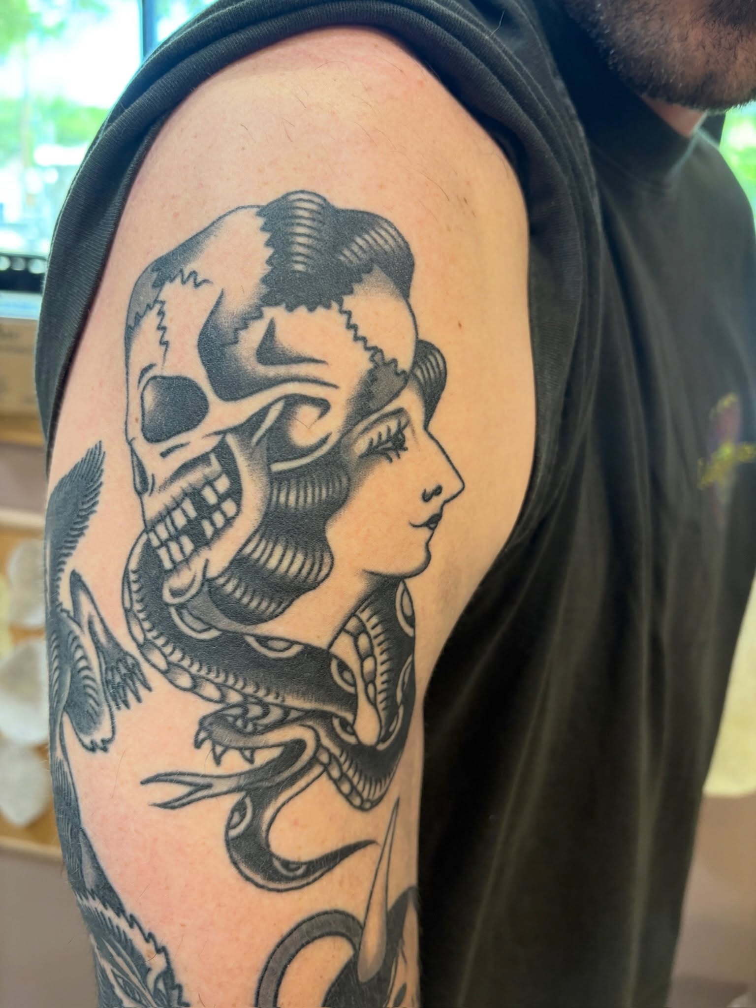 Skull and woman American traditional tattoo on the upper arm by Sammy Tattoo, Austin, Texas