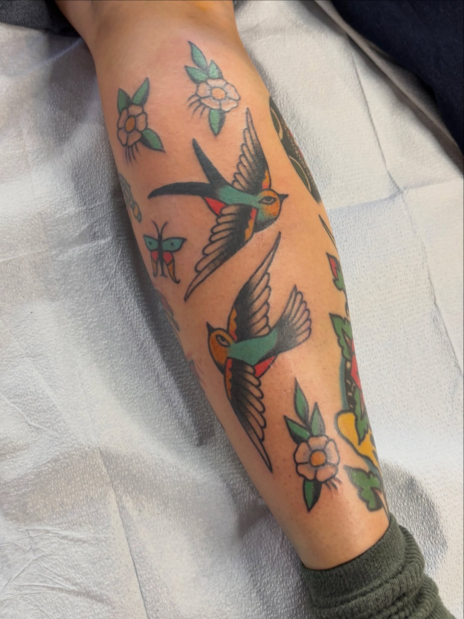Birds and flowers American traditional tattoo on the forearm by Sammy Tattoo, Austin, Texas