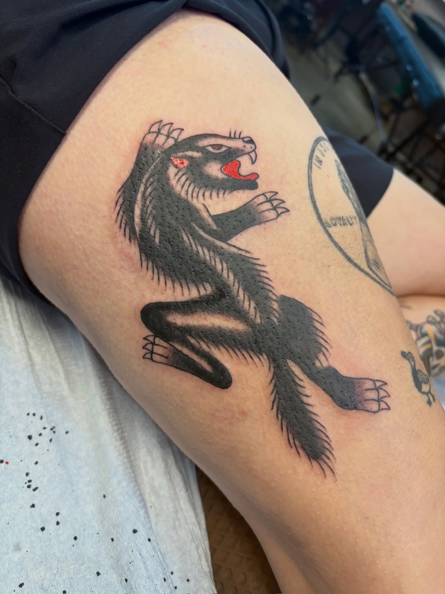 Ferret American traditional tattoo on the thigh by Sammy Tattoo, Austin, Texas