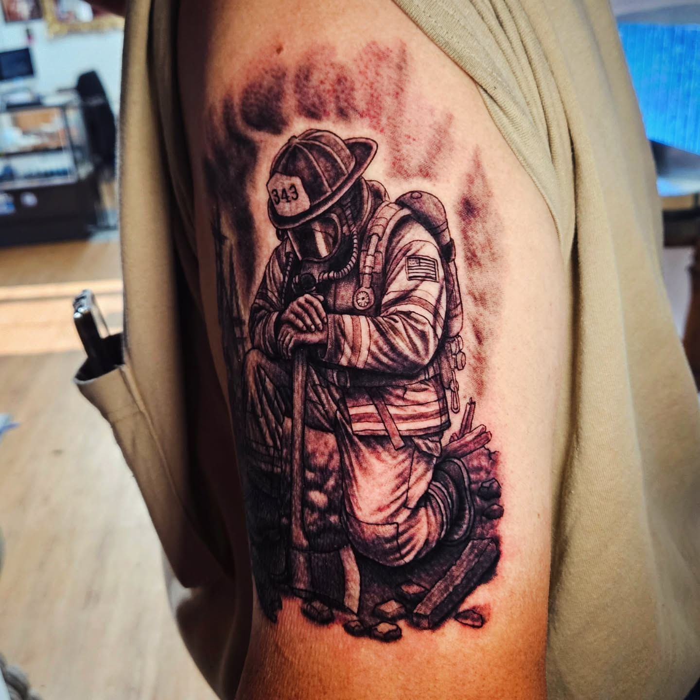 Firefighter kneeling realism tattoo on the forearm by Isaac Morales