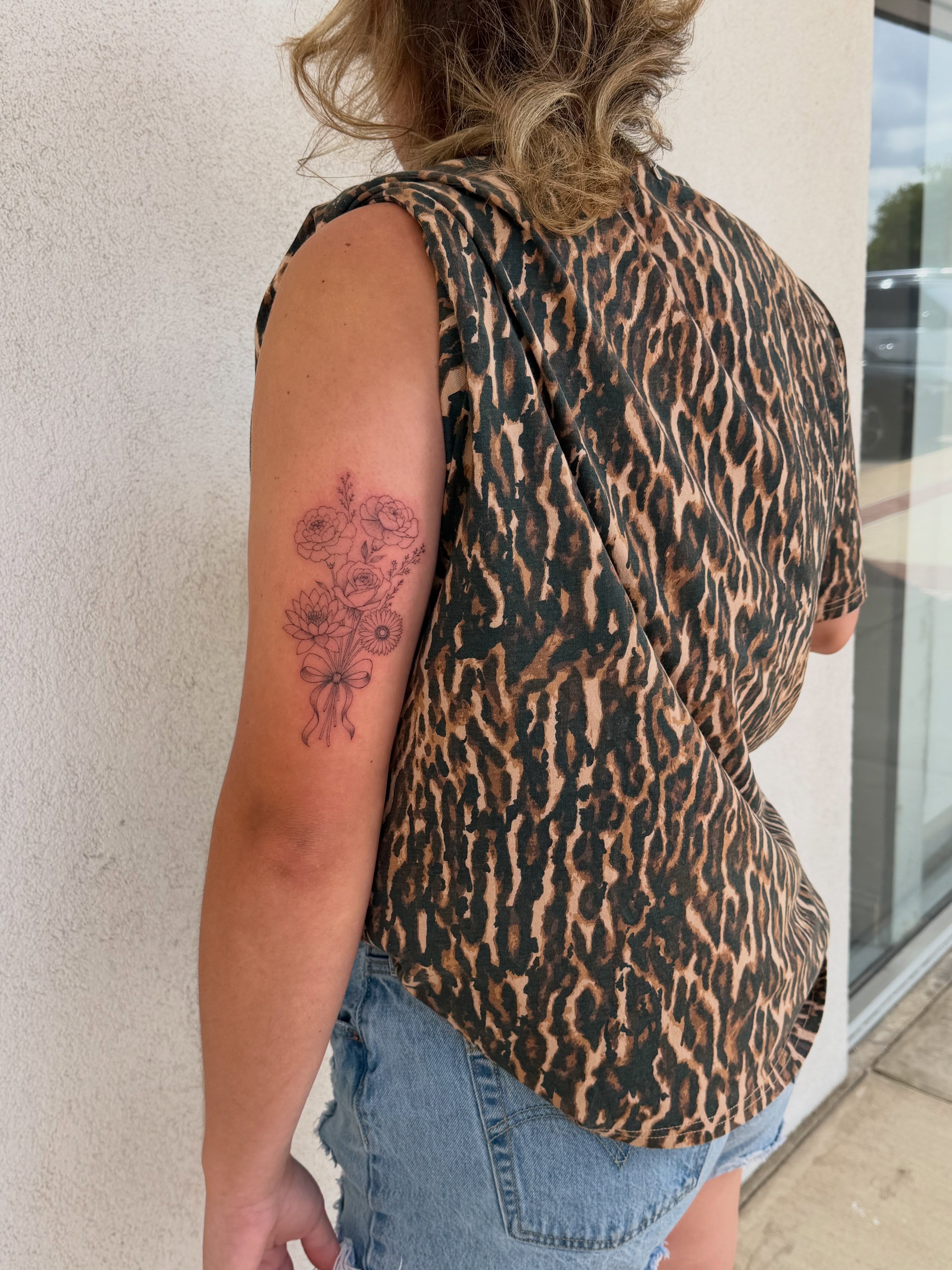 Flower bouquet dotwork tattoo on the upper arm by Jacksyn, Plano, Texas