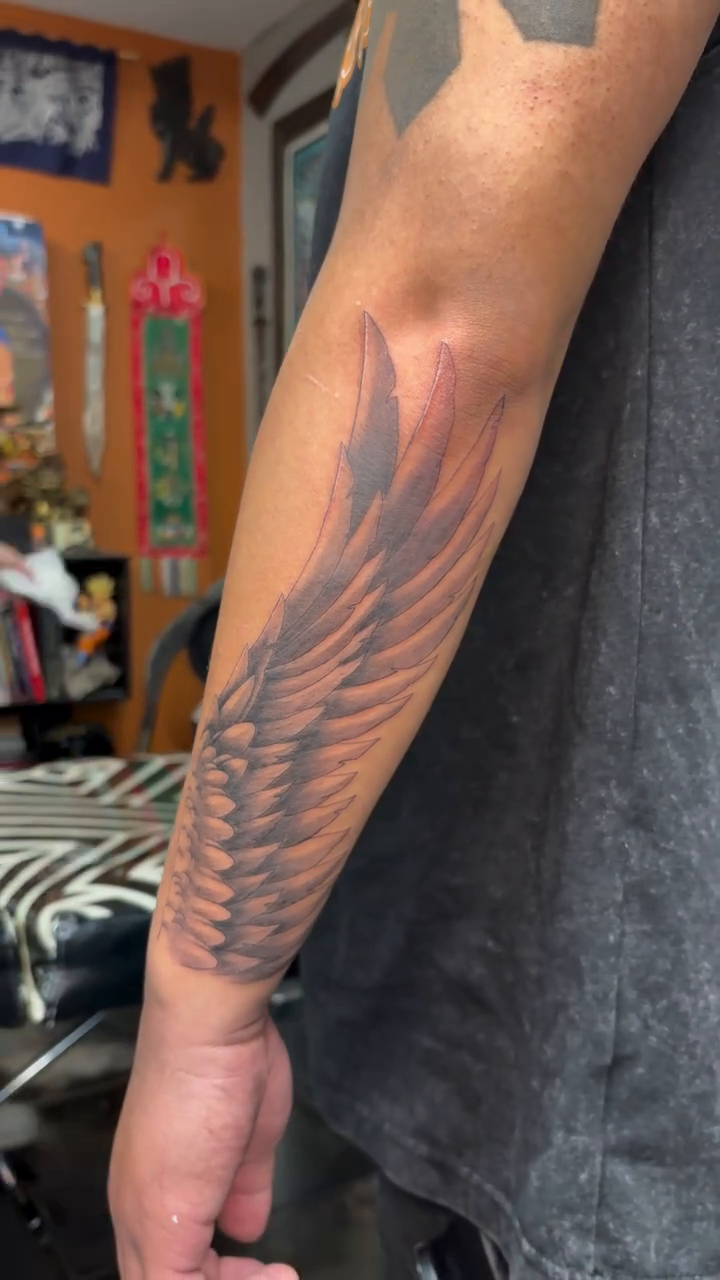 Angel wings realism tattoo on the forearm by alana khounmeuang