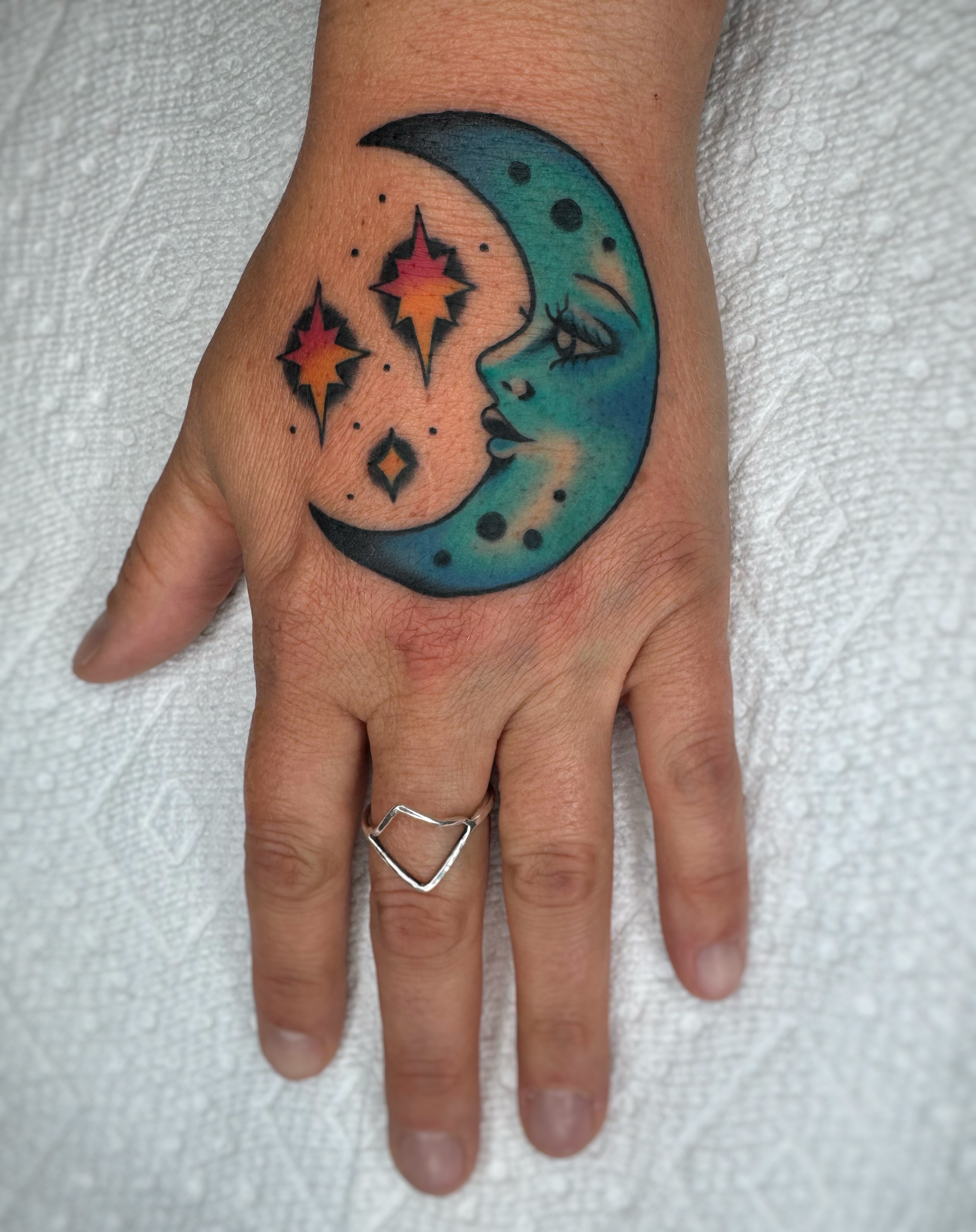 Moon and stars geometric tattoo on the hand by Cori James Tattoo Artist