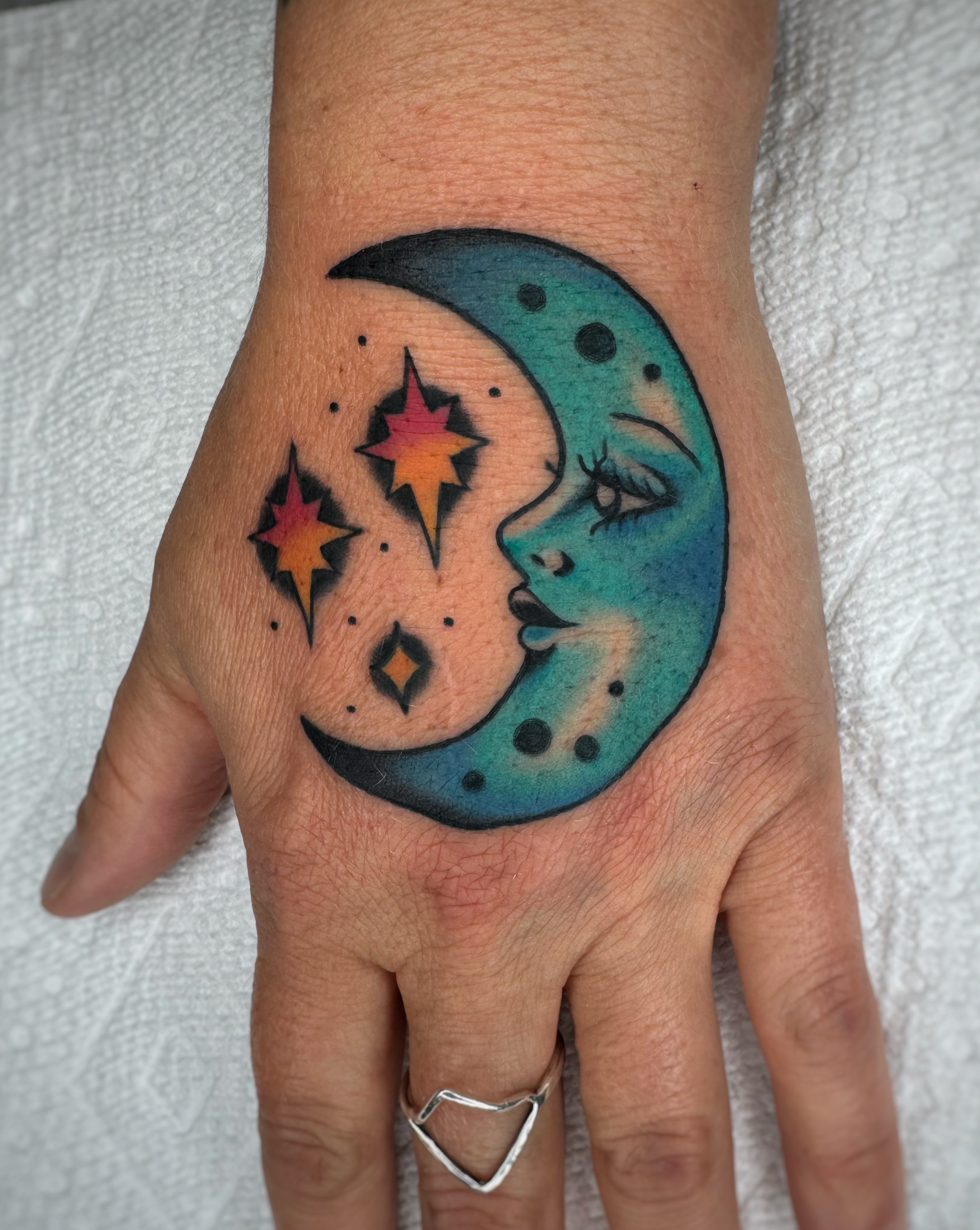 Moon and stars dotwork tattoo on the hand by Cori James Tattoo Artist