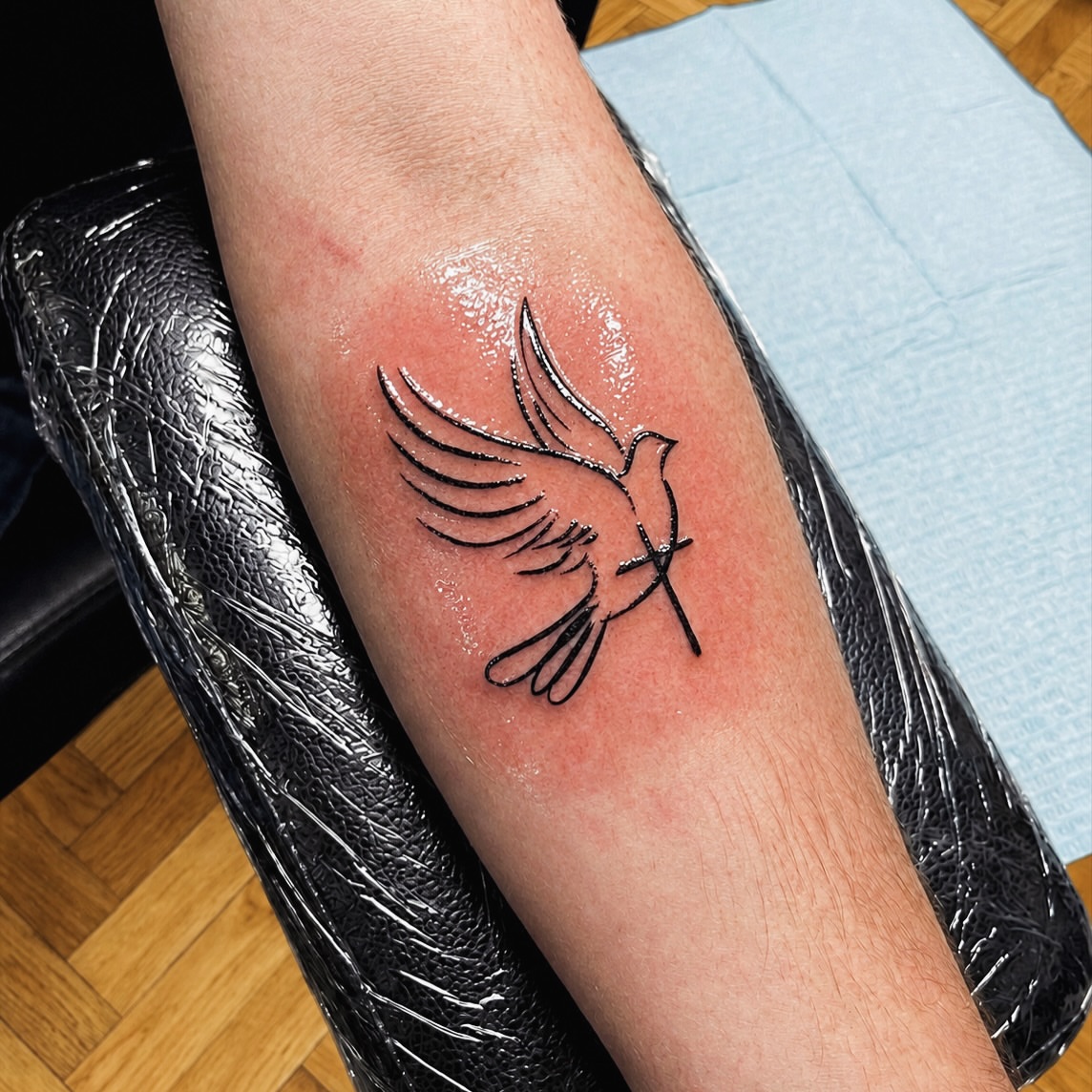 Bird fine line tattoo on the forearm by I N K S L A y e R
