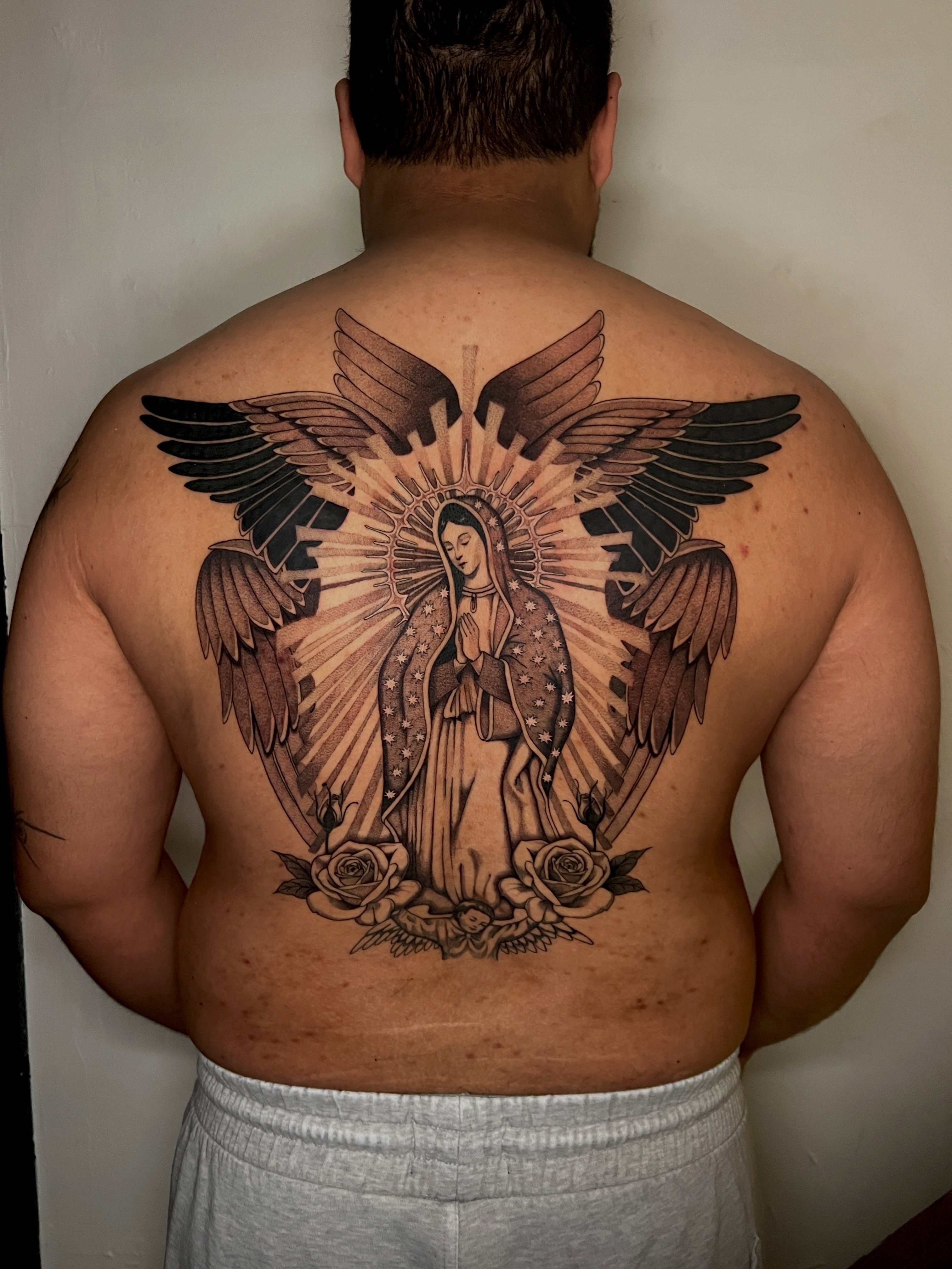 Our Lady of Guadalupe black and grey tattoo on the back by AJ π°π· LA tattoo